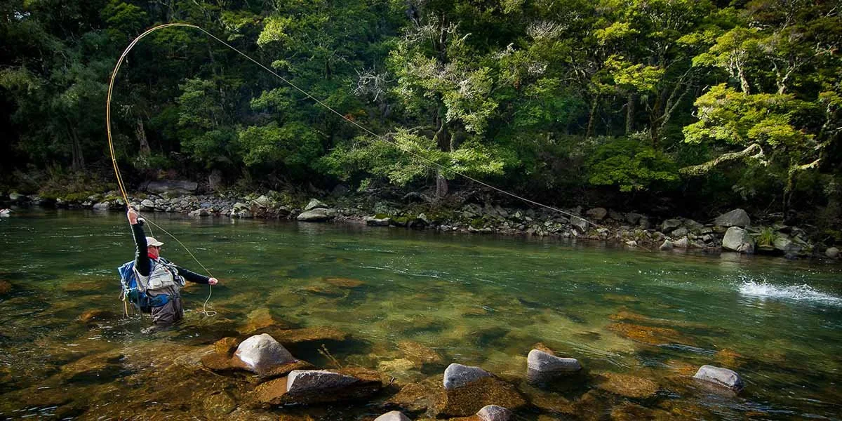 Guest wading in the river, fly fishing near Stonefly Lodge
