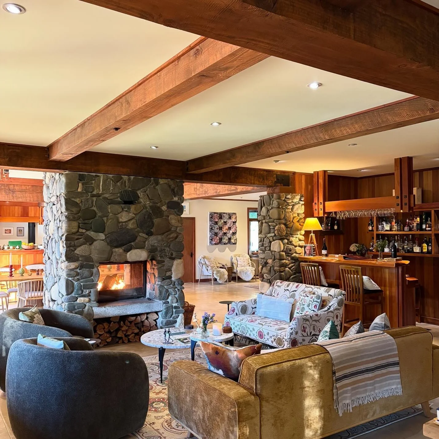 Cozy lounge with lit fireplace and relaxed seating at Stonefly Lodge