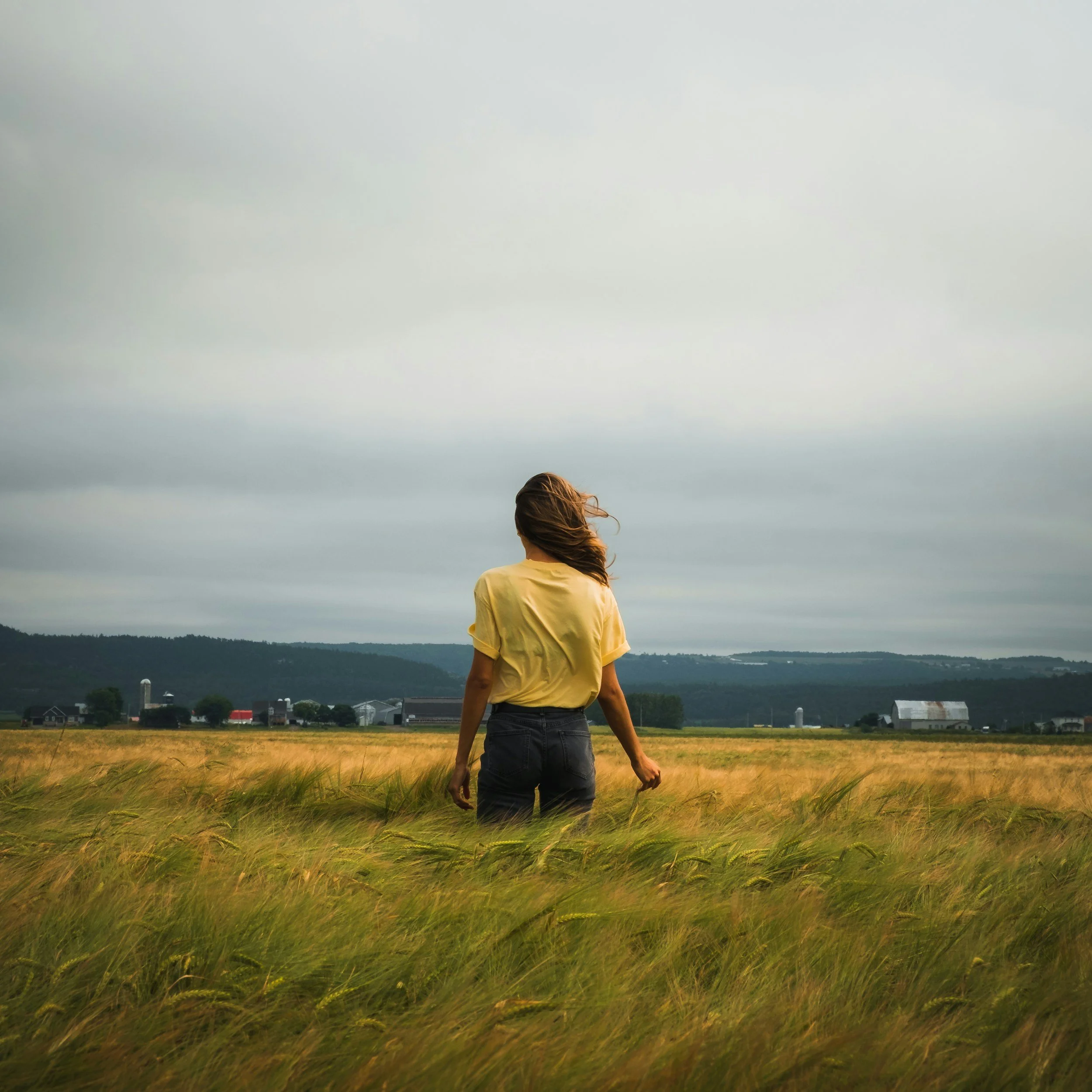 woman in a tall grass field.
