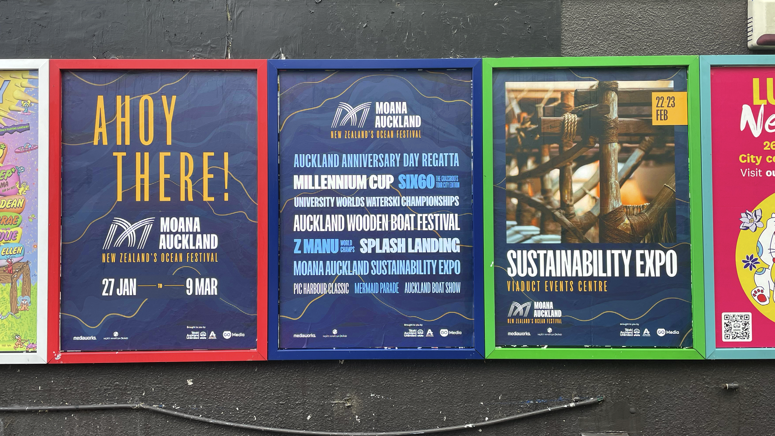 Four framed posters on a wall promoting Moana Auckland New Zealand's Ocean Festival.