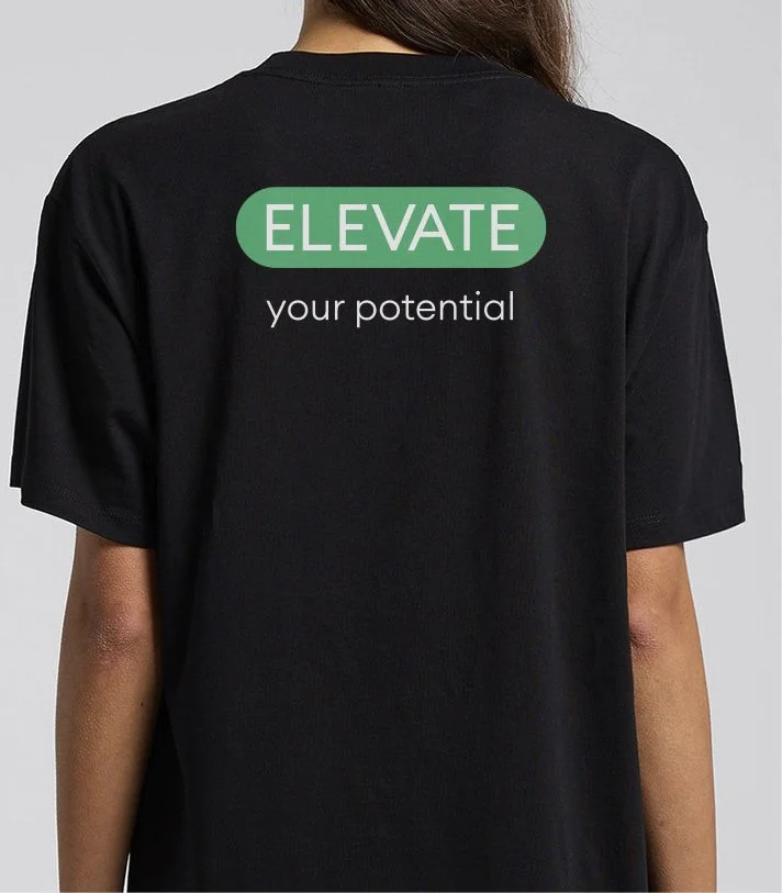 Back view of a person wearing a black T-shirt with the text 'ELEVATE your potential' printed on it.