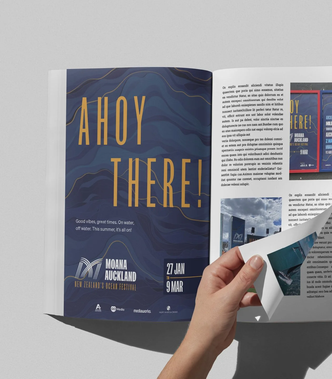 Open magazine featuring a page with large yellow text "AHOY THERE!" on a blue, marbled background. Smaller text under it reads "Good vibes, great times. On water, off water. This summer, it`s all on!" with event details for MOANA AUCKLAND from January 27 to March 9, 2023.