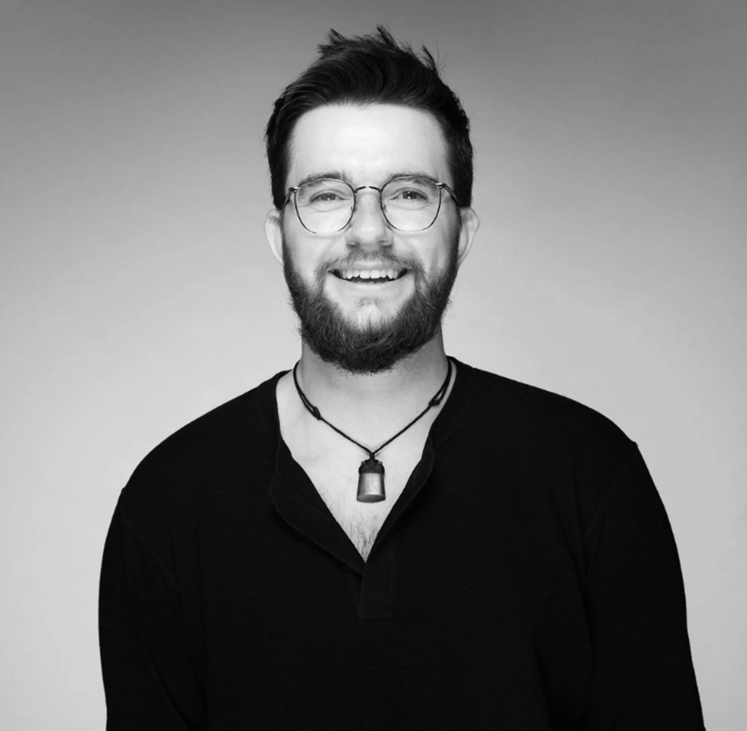 Black and white portrait of a man smiling