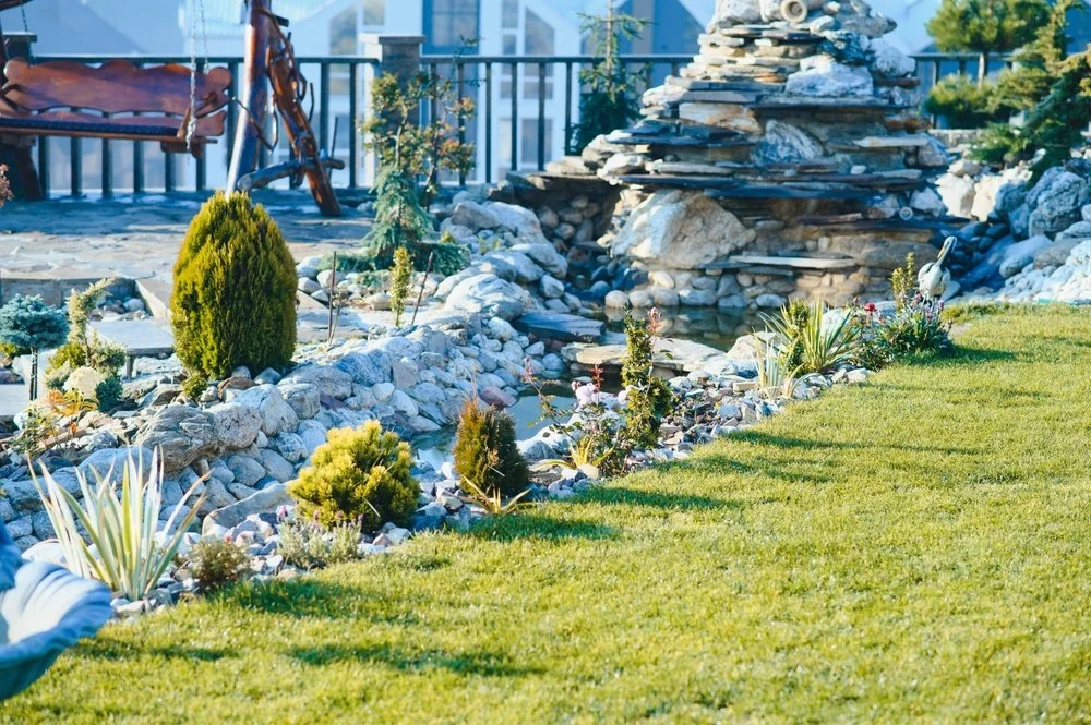 Decorative rock fountain surrounded by stone landscaping in an Aurora xeriscape design by RDS Hardscape