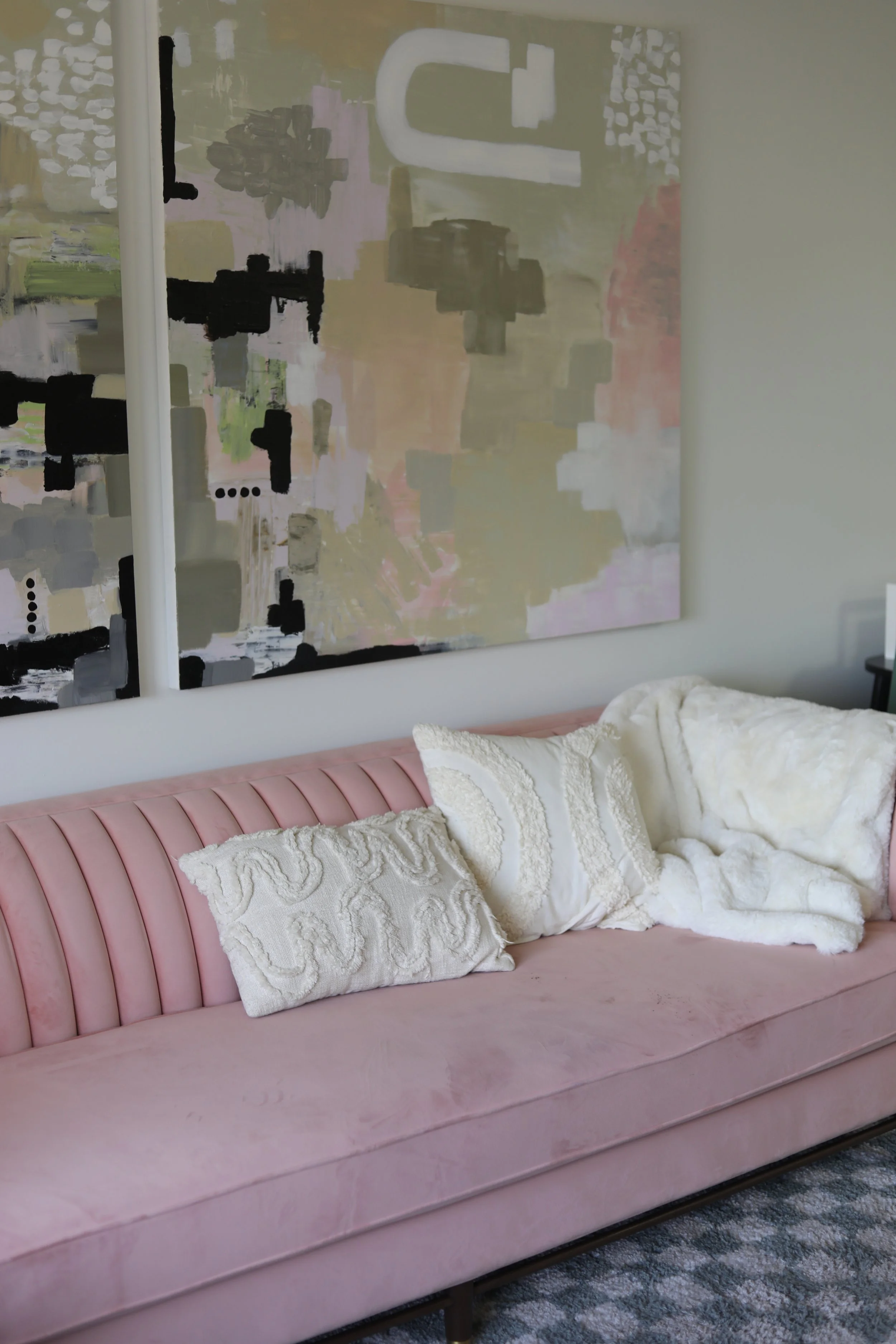 Cozy therapy office with pink couch, abstract artwork, and seating area in an Irvine therapy practice.