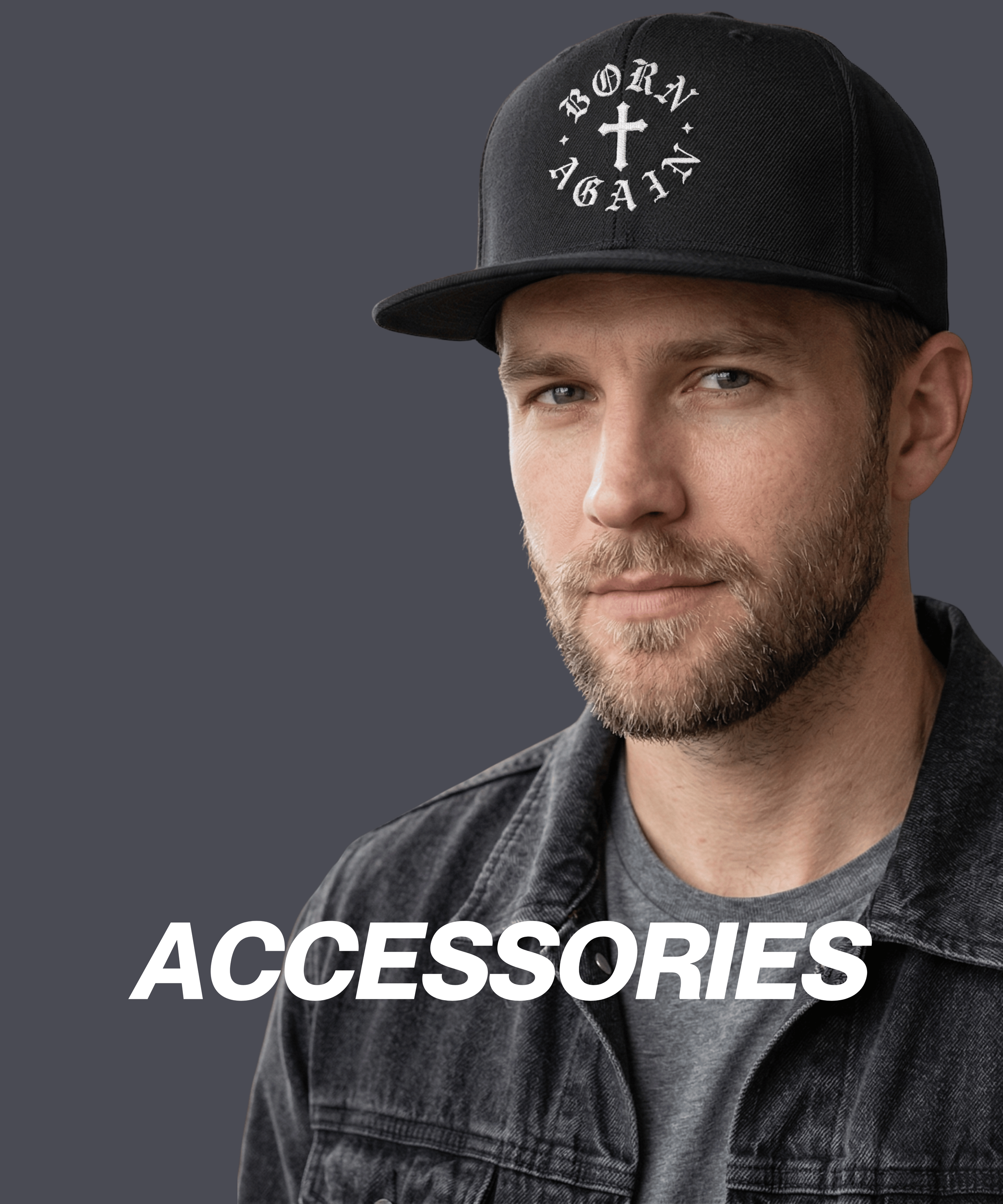 A man wearing a black baseball cap with a white cross and text design, a gray t-shirt, and a black denim jacket against a dark gray background. The word 'ACCESSORIES' is written in bold white letters across the lower part of the image.