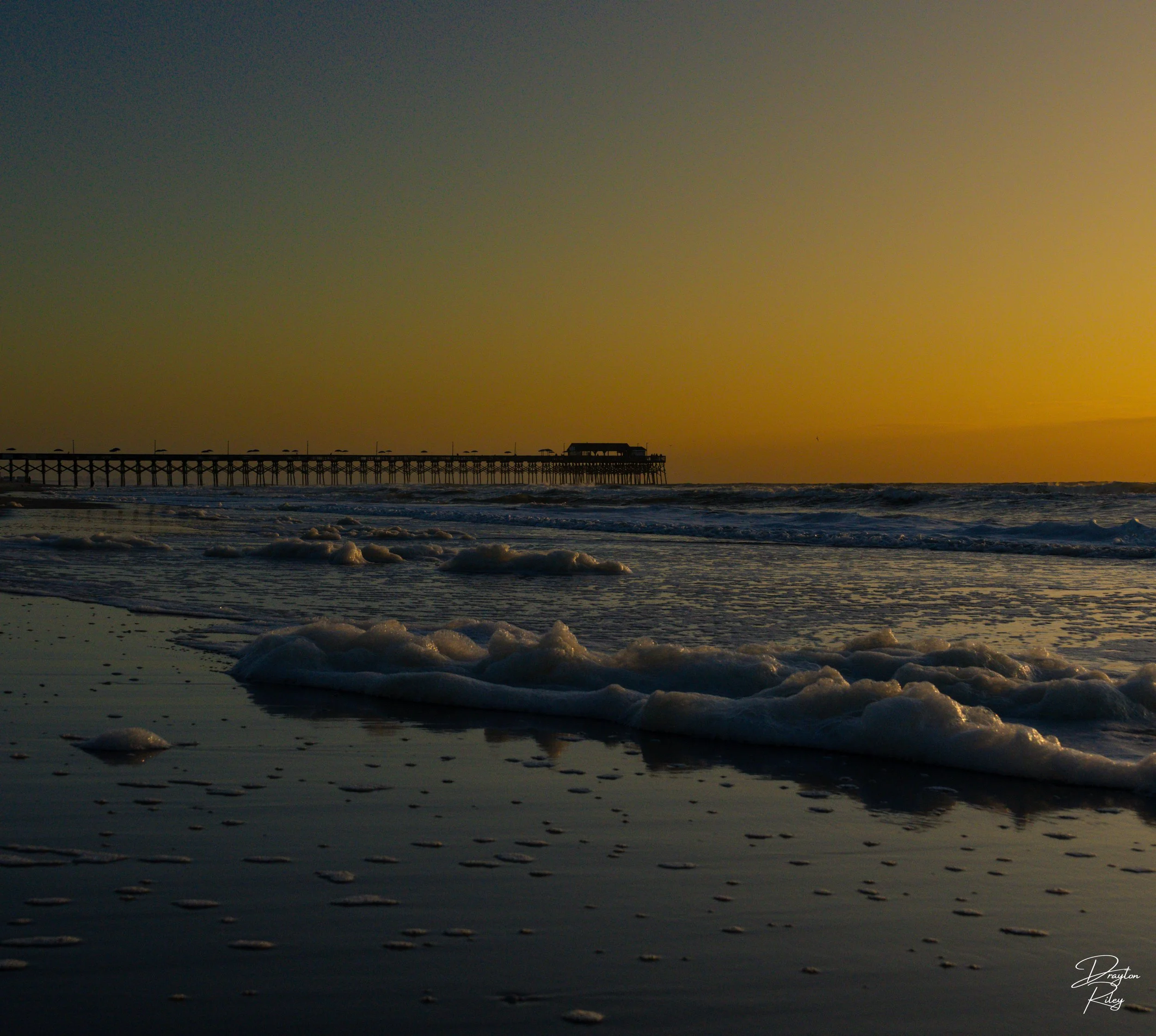 The pier stretches gracefully into the horizon, its silhouette etched against the vibrant backdrop.
~Murrels Inlet, South Carolina