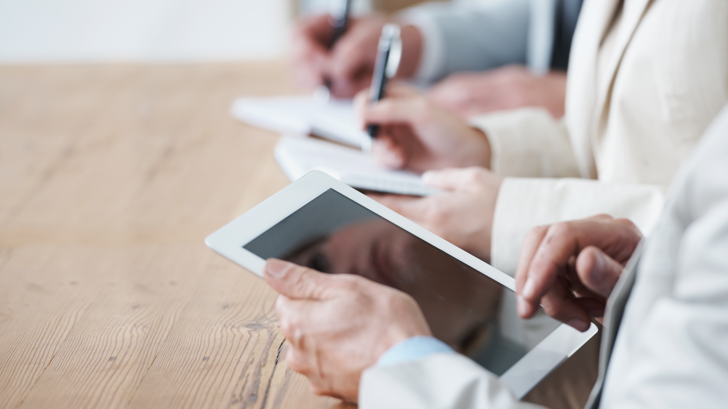 business people looking at iPads