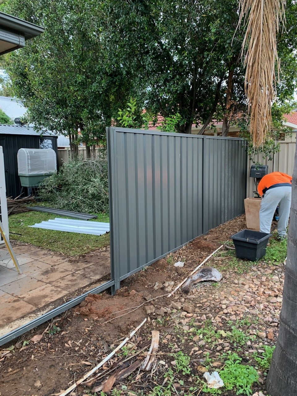 New Colorbond Good Neighbour fence sheets being installed.