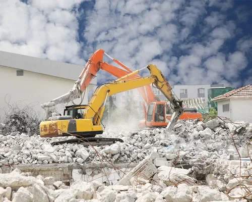 Demolition site with diggers knocking over a building