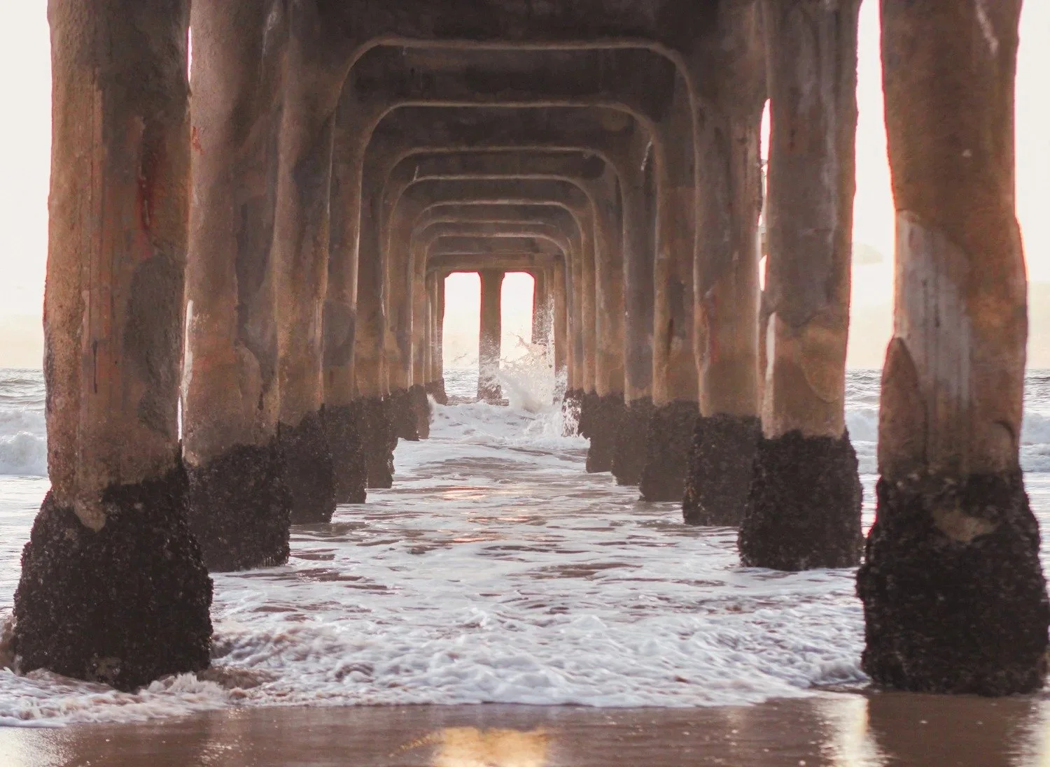 Waves rolling beneath the Manhattan Beach Pier
