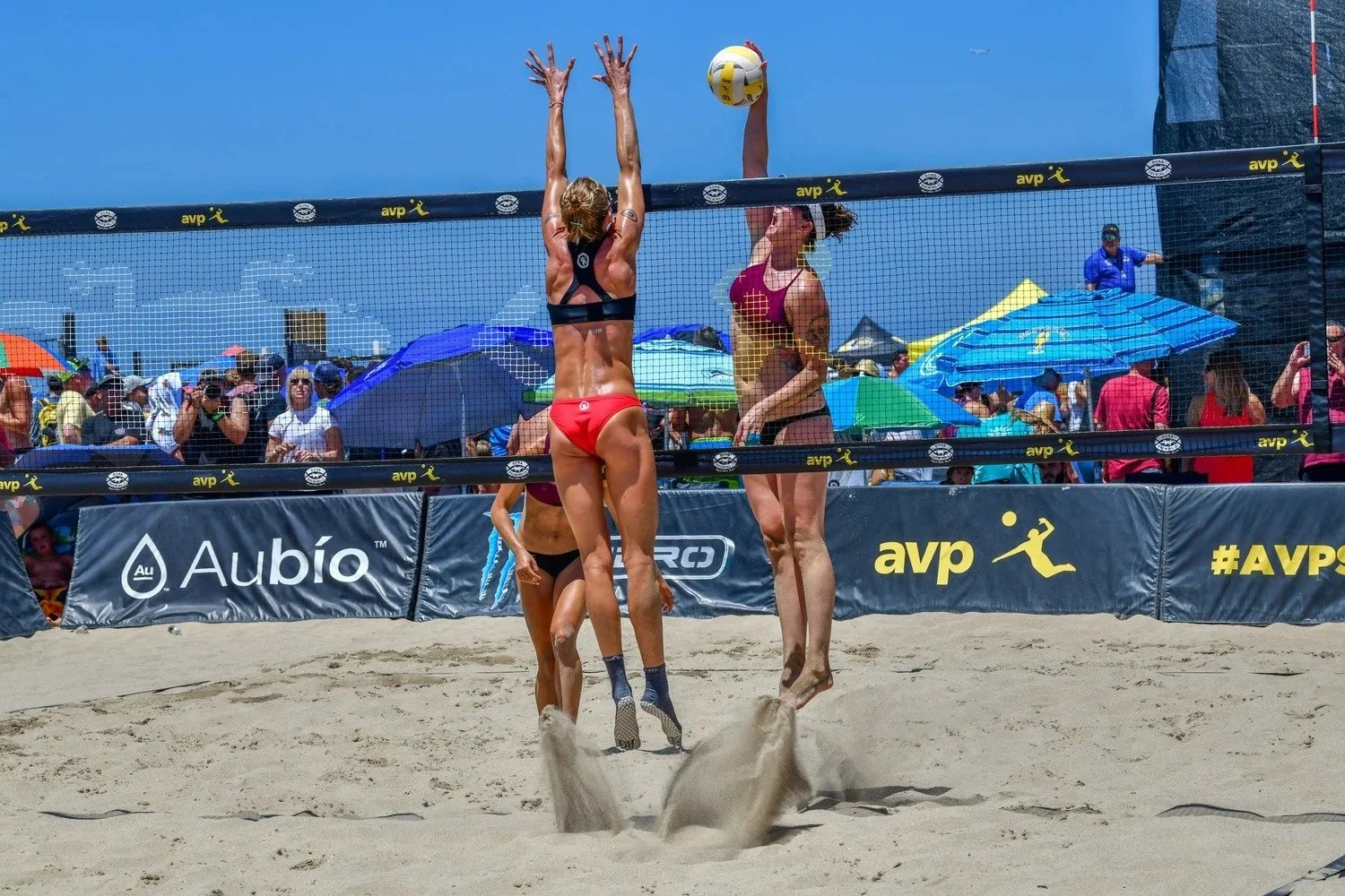 Beach volleyball players competing on sand