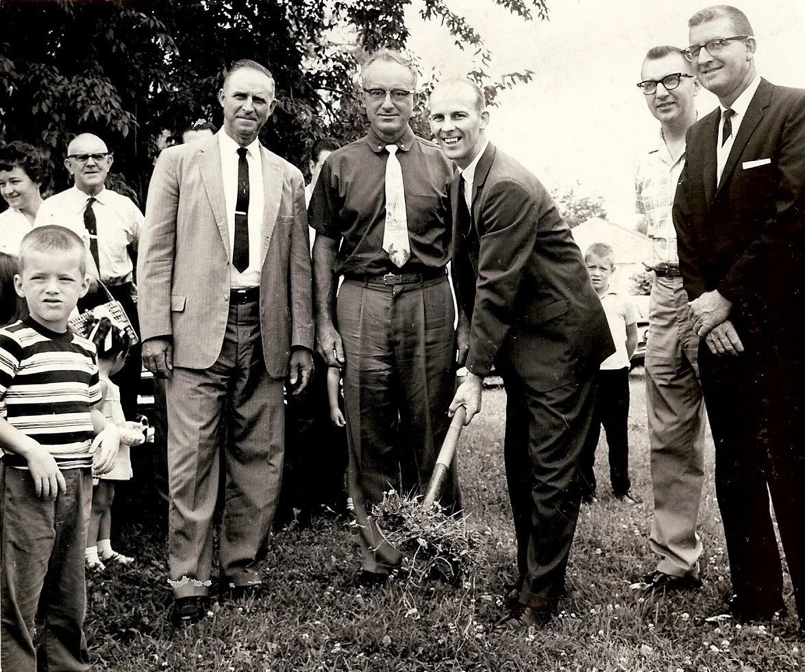 Wayne Warner with shovel in preparation for the building of the parsonage. Church members around Rev. Warner include Dale Stalter on the left, Mrs. Roberts left in back, Mr. Gardner, Mr. Connel, Mr. Stalter, Mr. Wittrig, and Mr. Schmidgall. This was