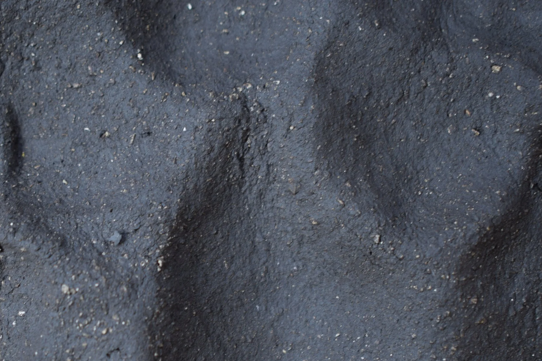 SOIL: Unglazed dark brown clay