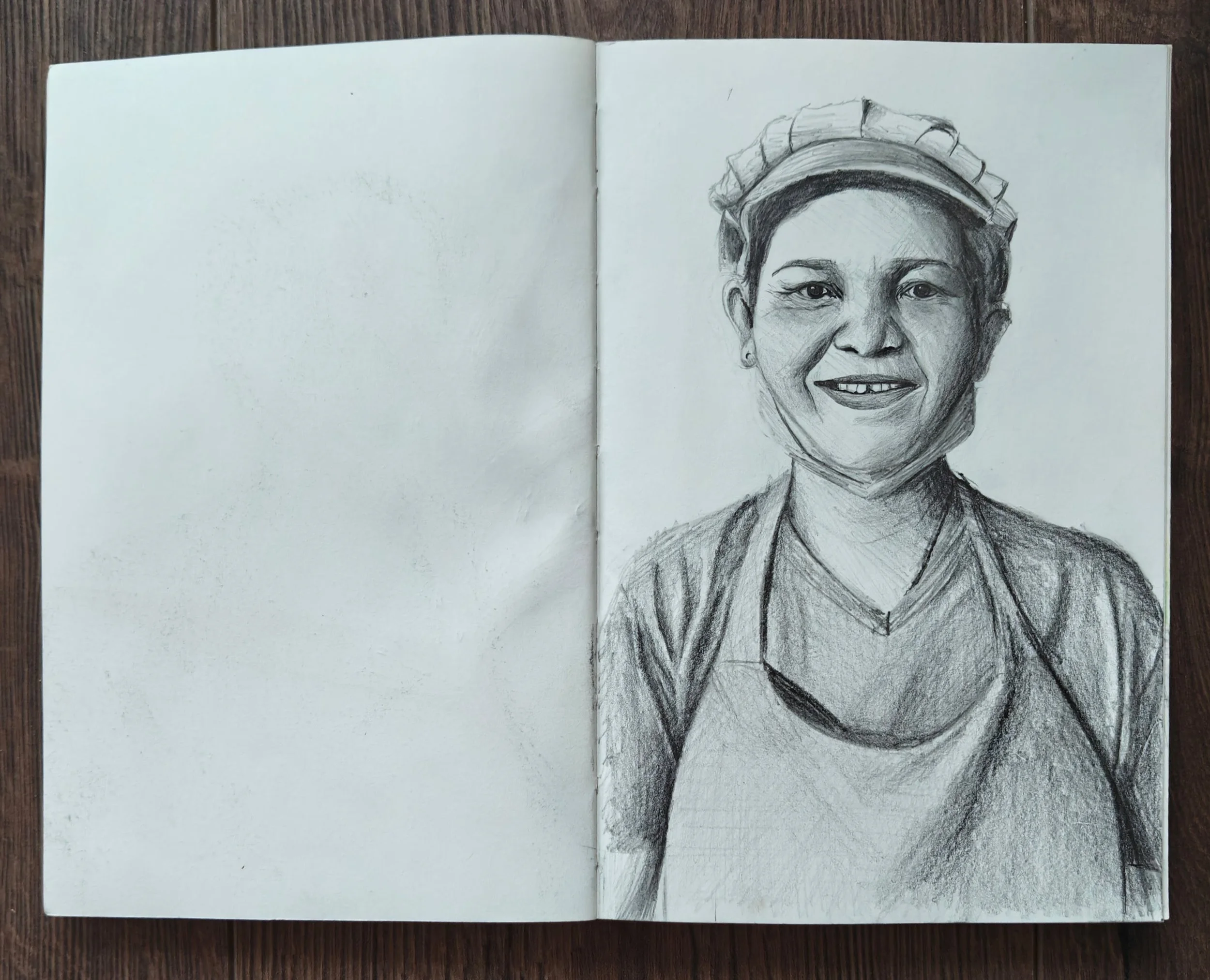 A sketch of a woman wearing a cap, with short hair, a V-neck shirt, and an apron, smiling at the camera.