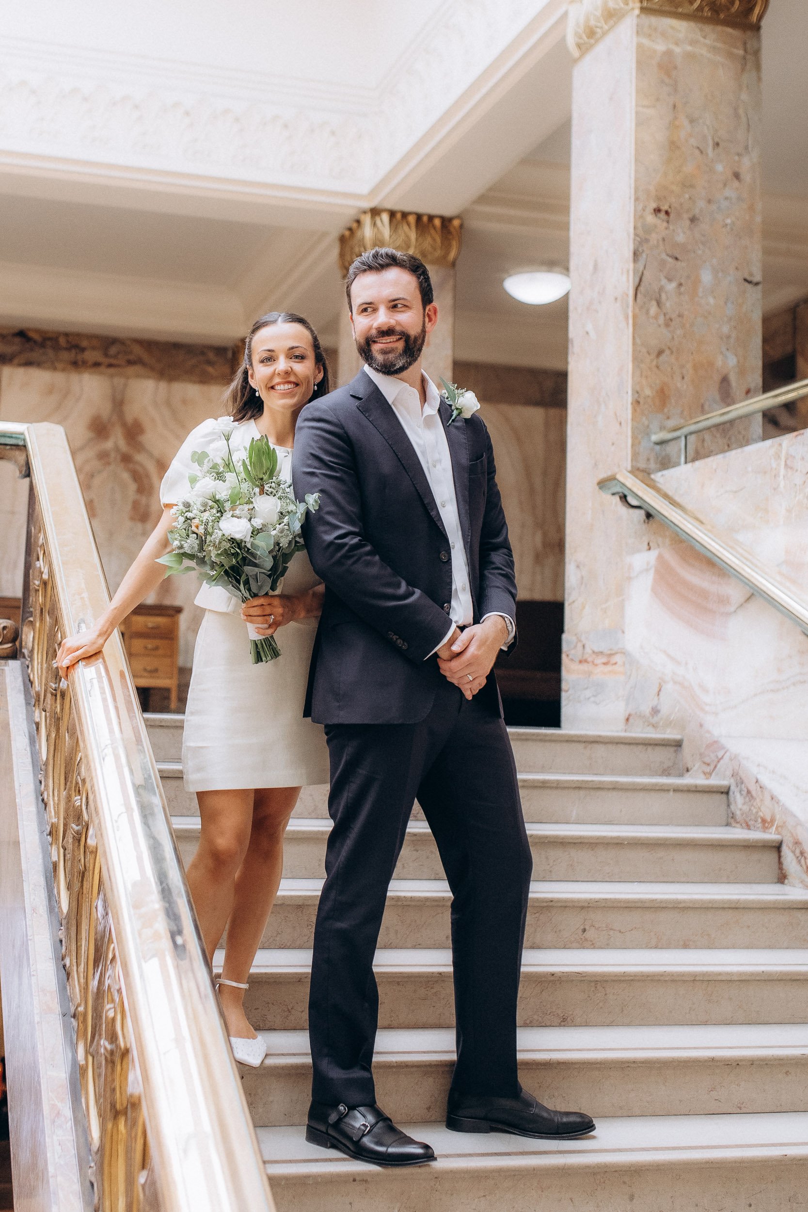  Bride and groom on the art deco marble staircase with its brass handrail, Wandsworth Town Hall 