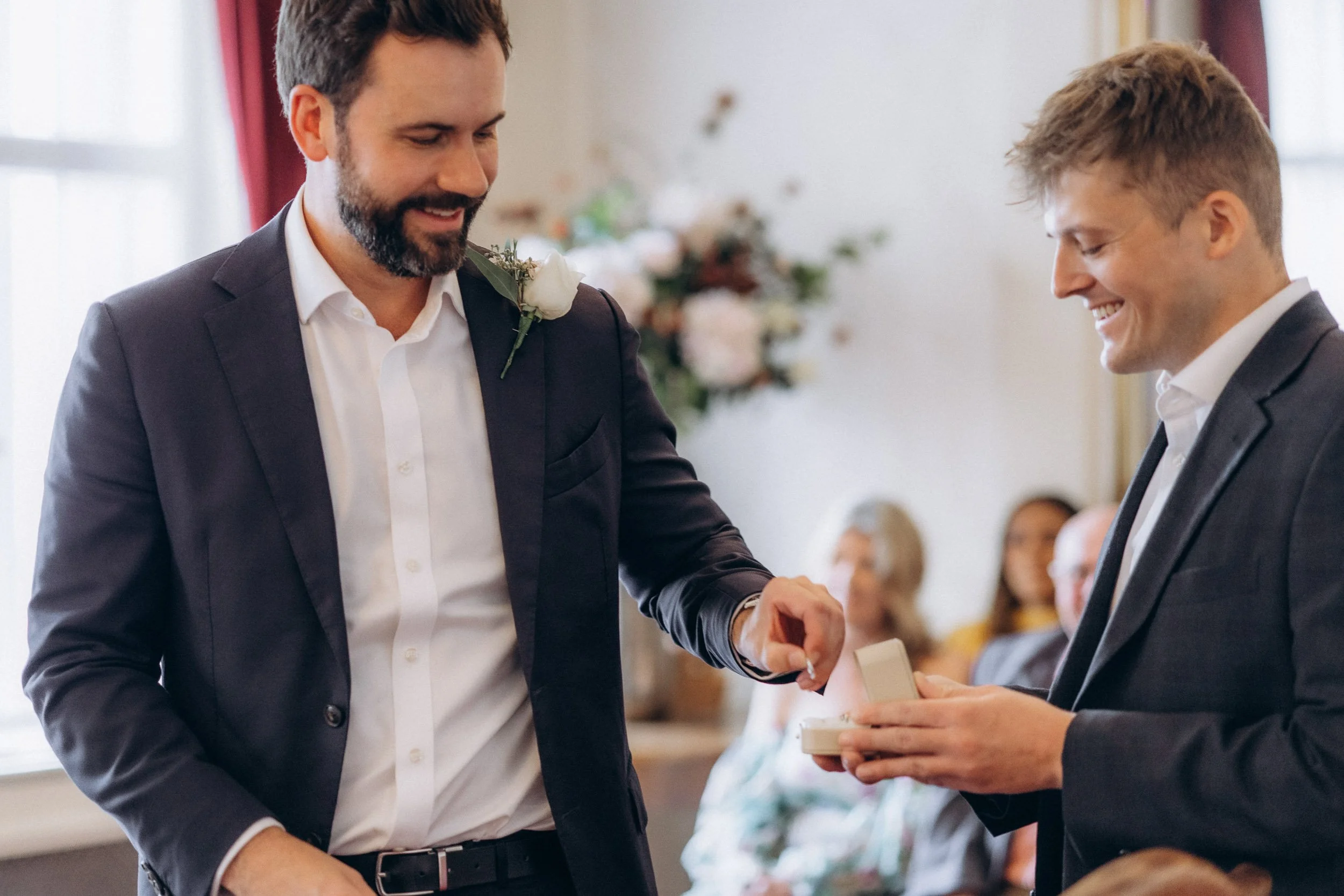  Groom taking the wedding ring from a guest during the ceremony at Wandsworth Town Hall 