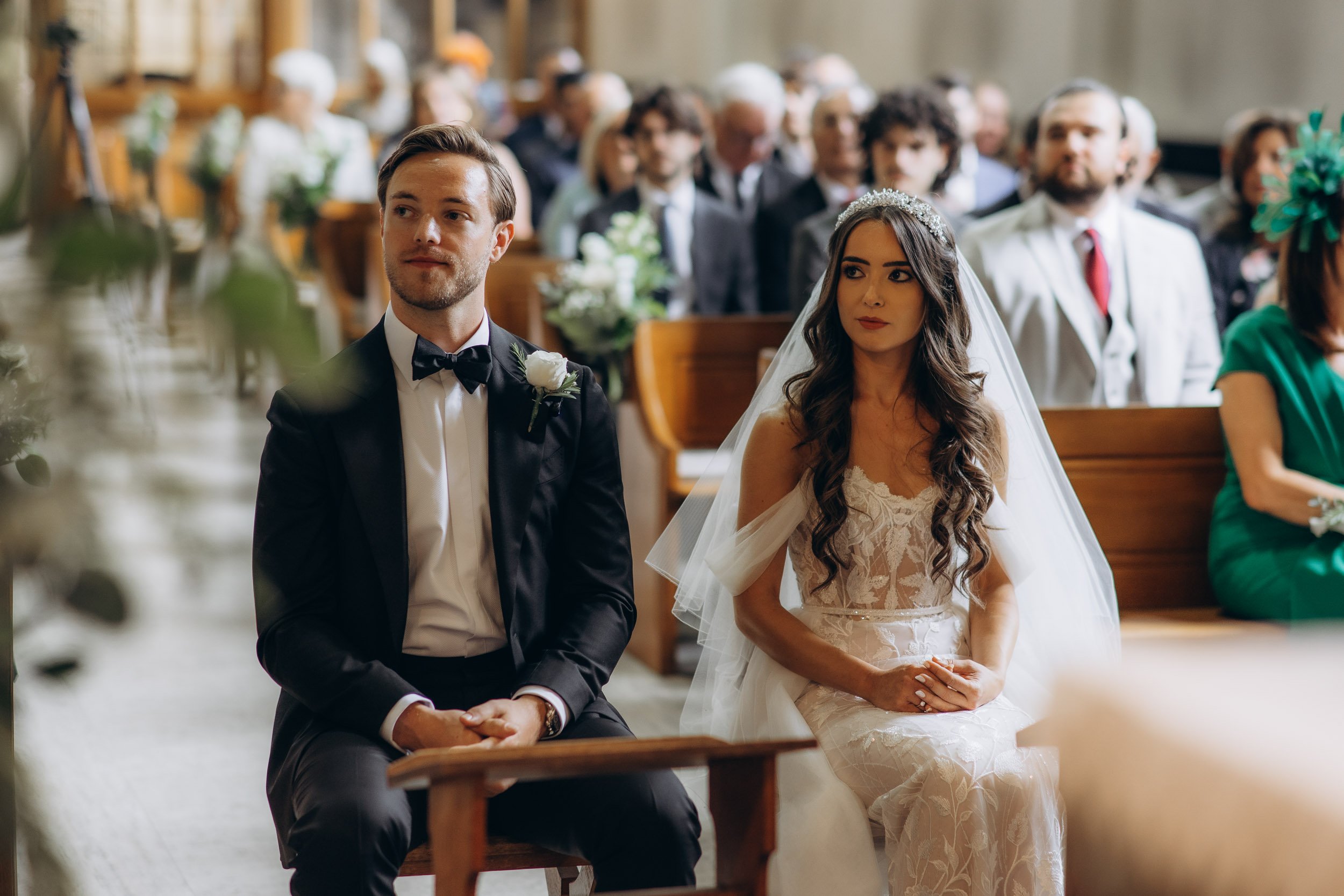 Authentic moment of a wedding couple seated at the altar during a traditional church ceremony in London.