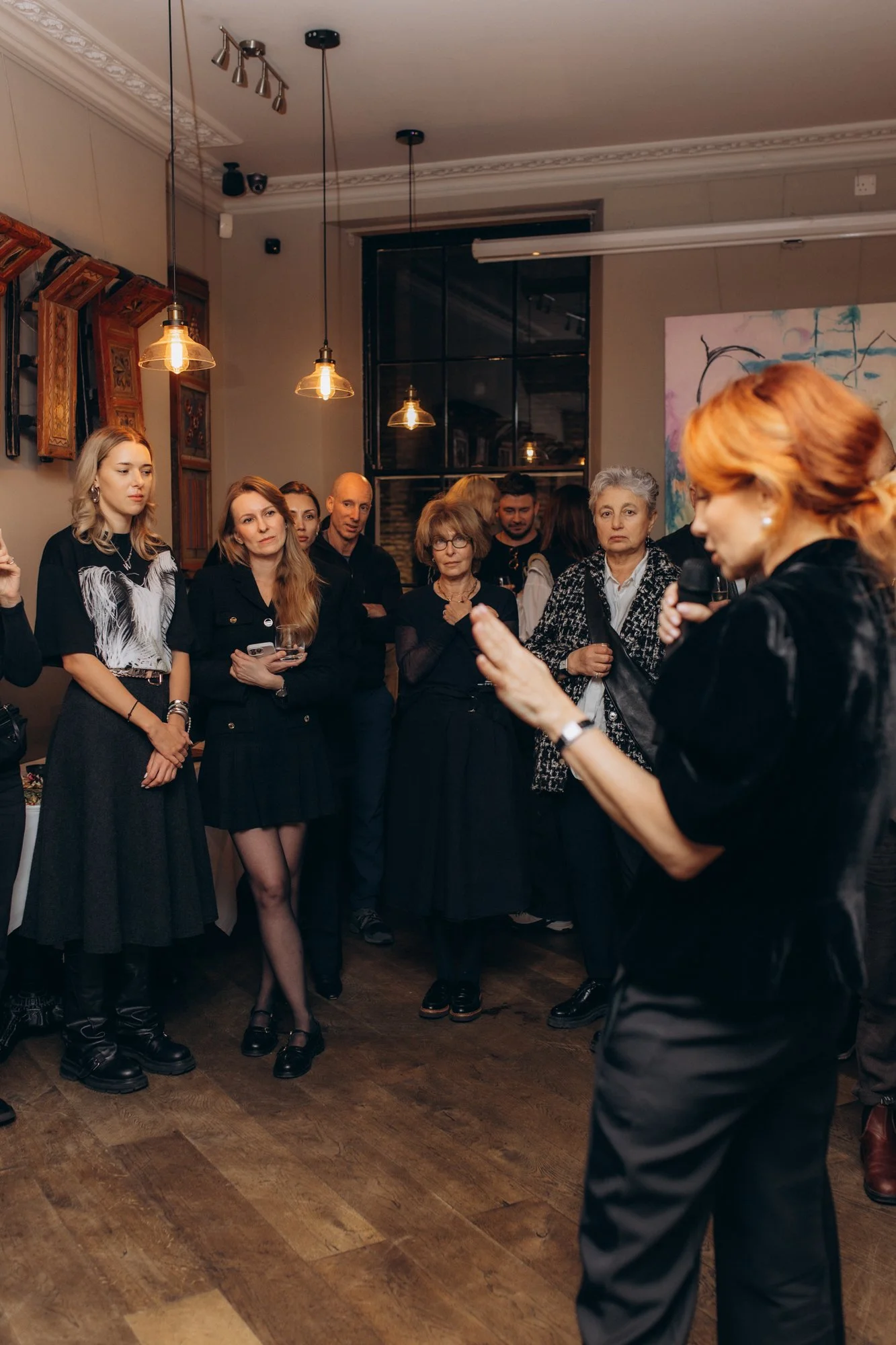 Guests gathering around an author at a book launch reception