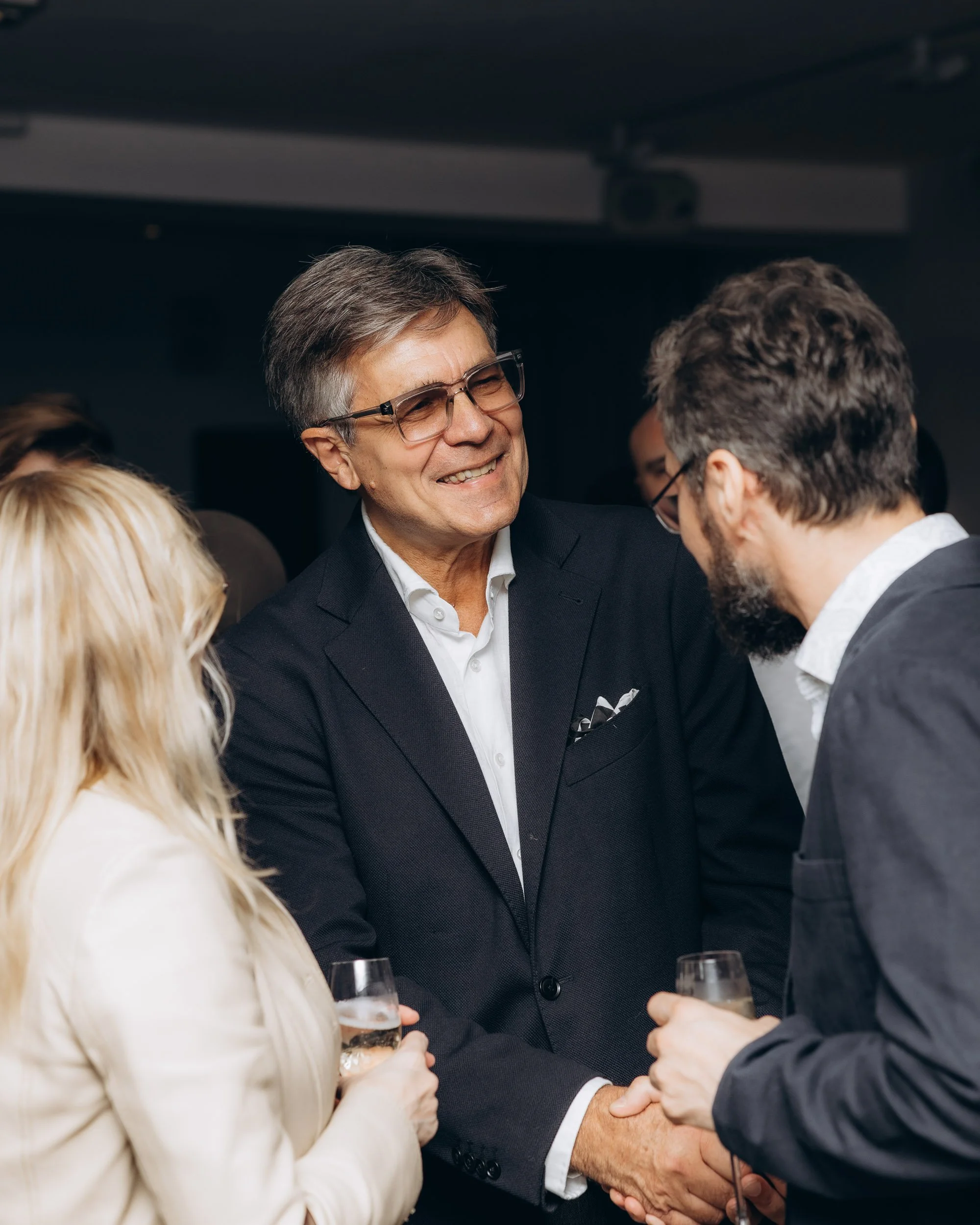 Two guests shaking hands at a London business event