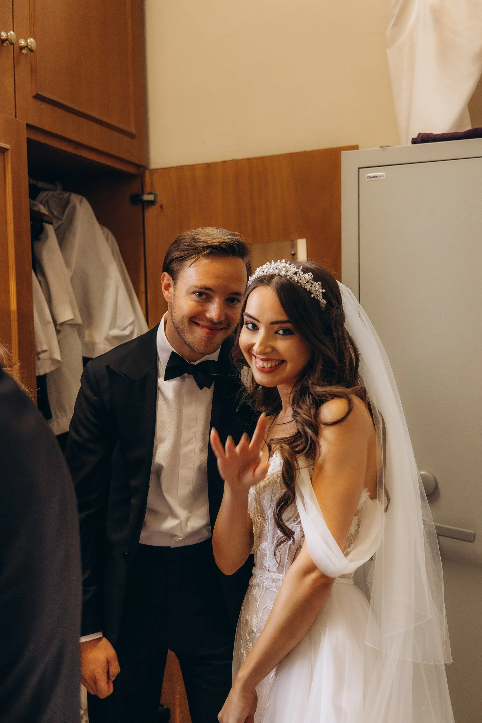 A relaxed, honest portrait of a newly married couple enjoying a quiet moment away from the crowd.