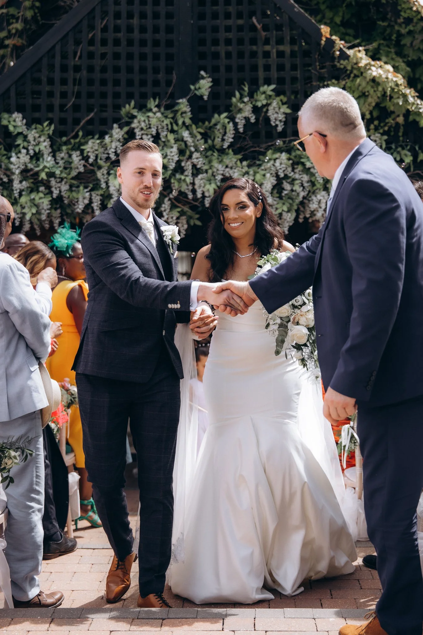 Father shaking the groom's hand before the wedding ceremony