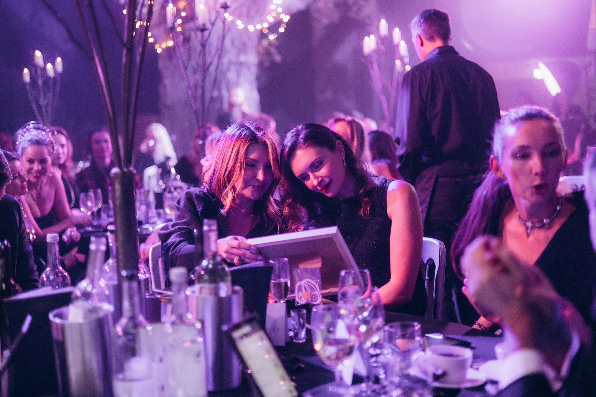 Packed dinner tables and candlelight at a London gala event