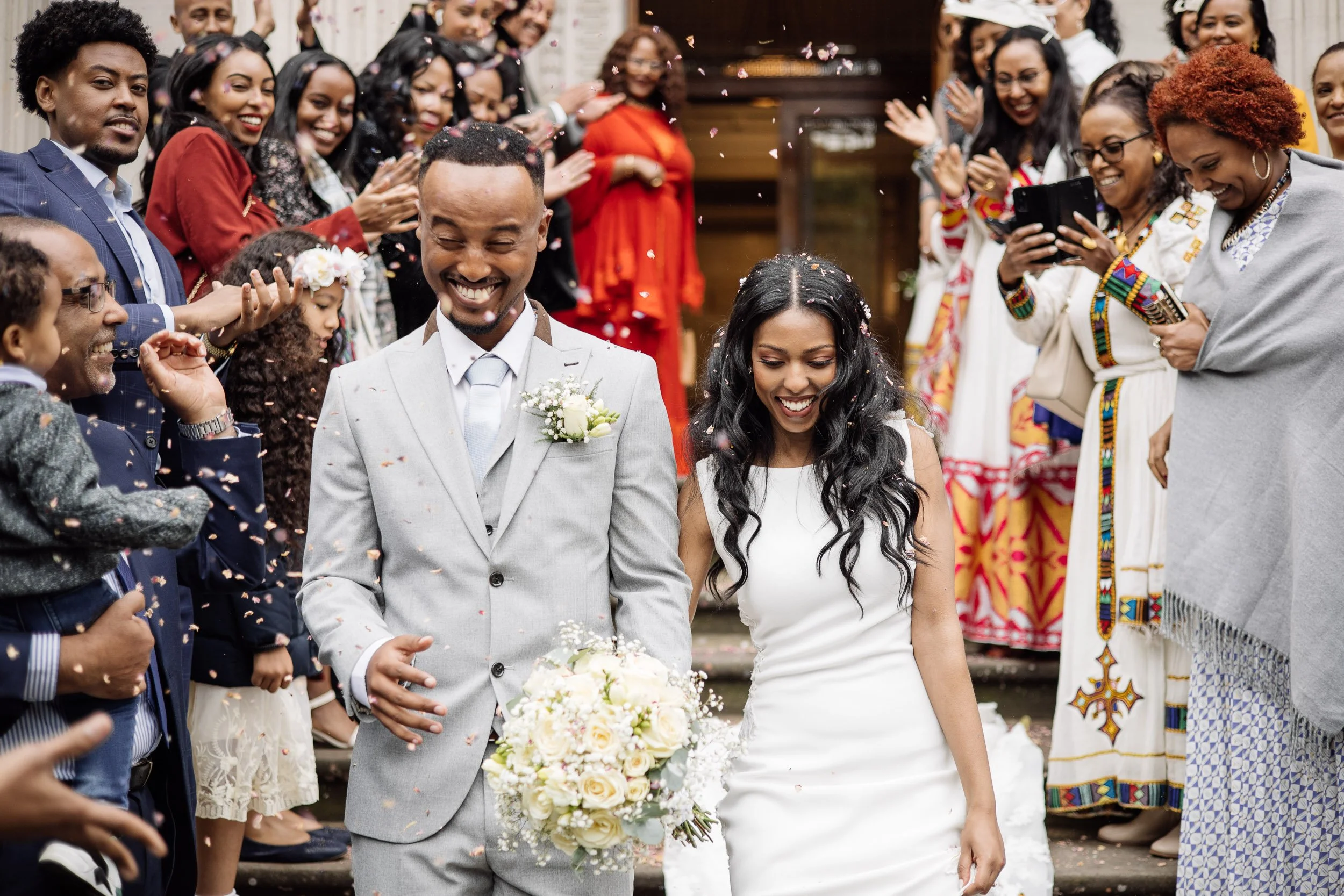 Wedding guests throwing confetti as the couple exits Old Marylebone Town Hall
