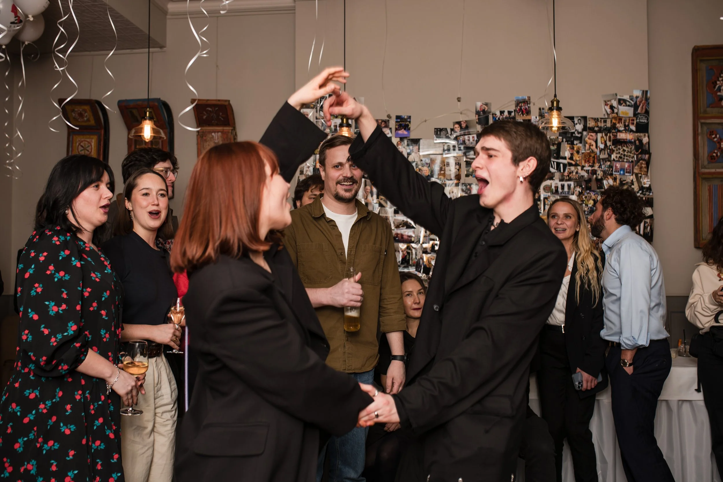 Guests dancing and laughing at a corporate party in a London restaurant