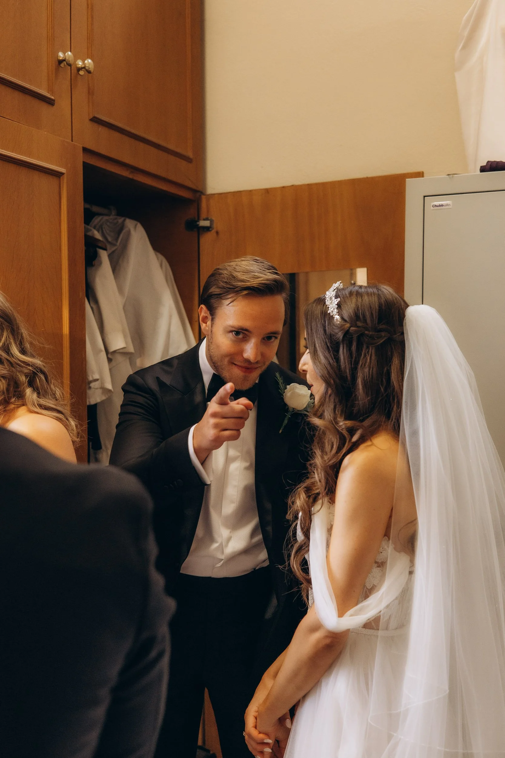 Fun and authentic candid moment of a groom and bride sharing a laugh during their London wedding day.