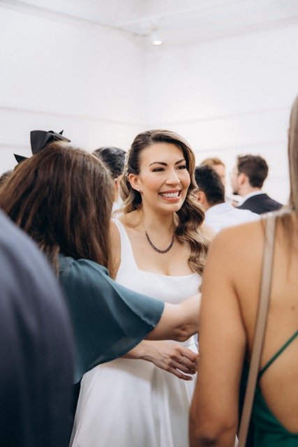 Bride laughing with a guest at the reception