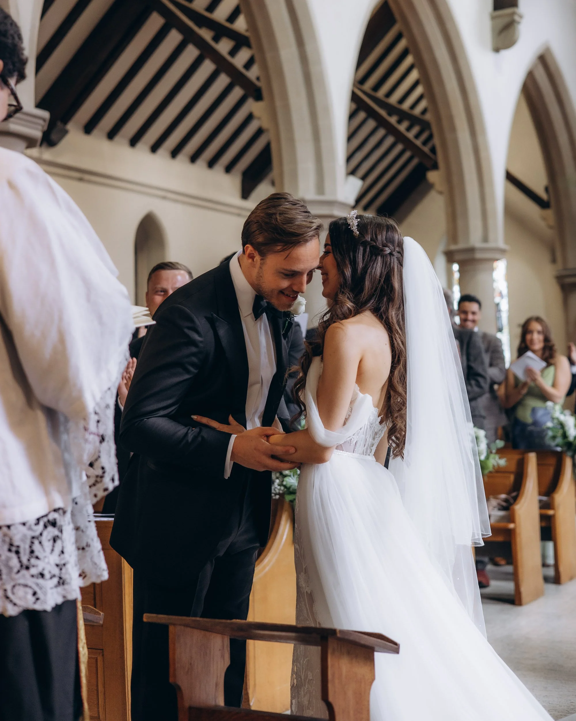 Emotional documentary wedding photography of a couple exchanging vows in a sun-drenched London church.