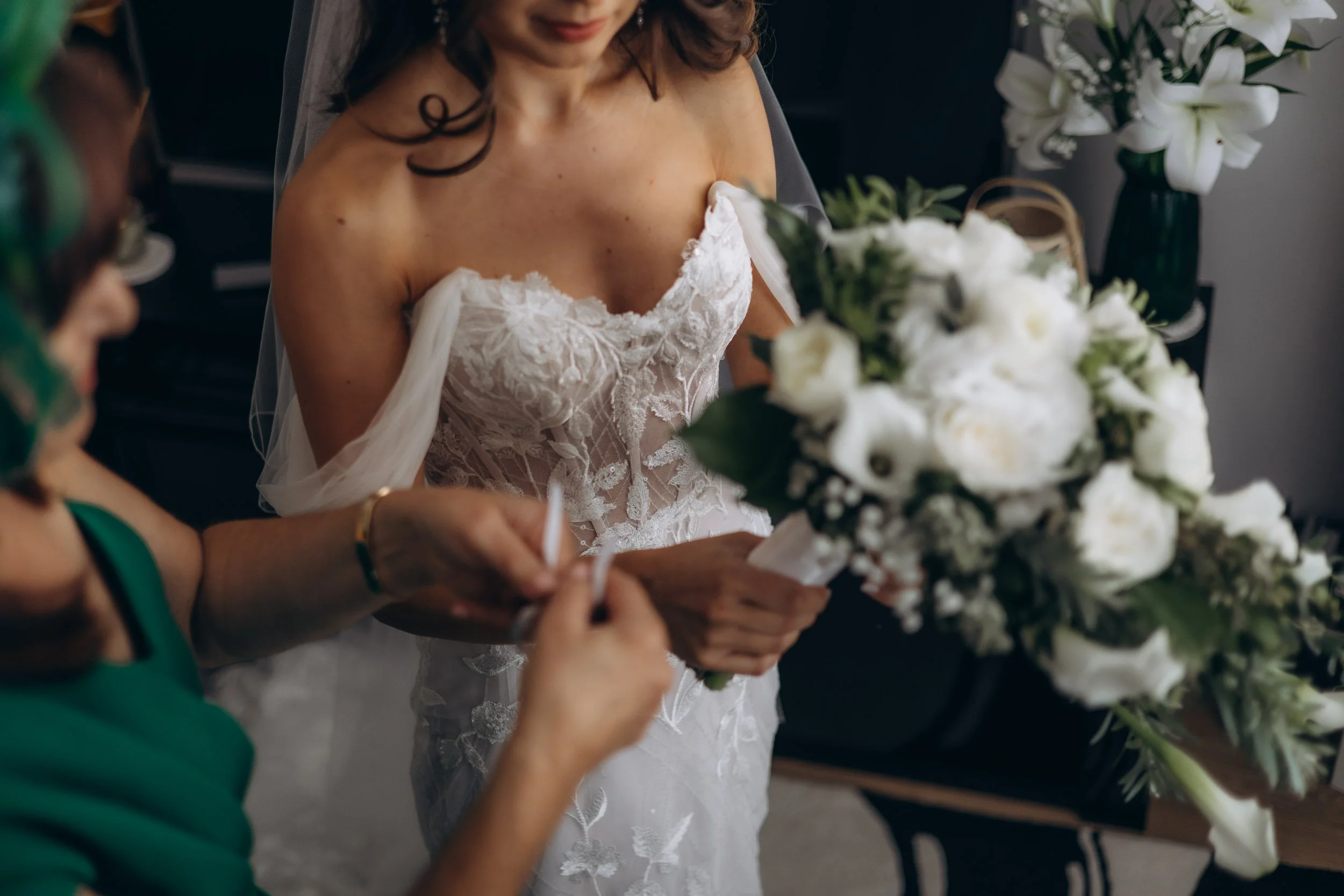 Close-up documentary shot of a bride's hands and floral bouquet during an intimate London wedding ceremony
