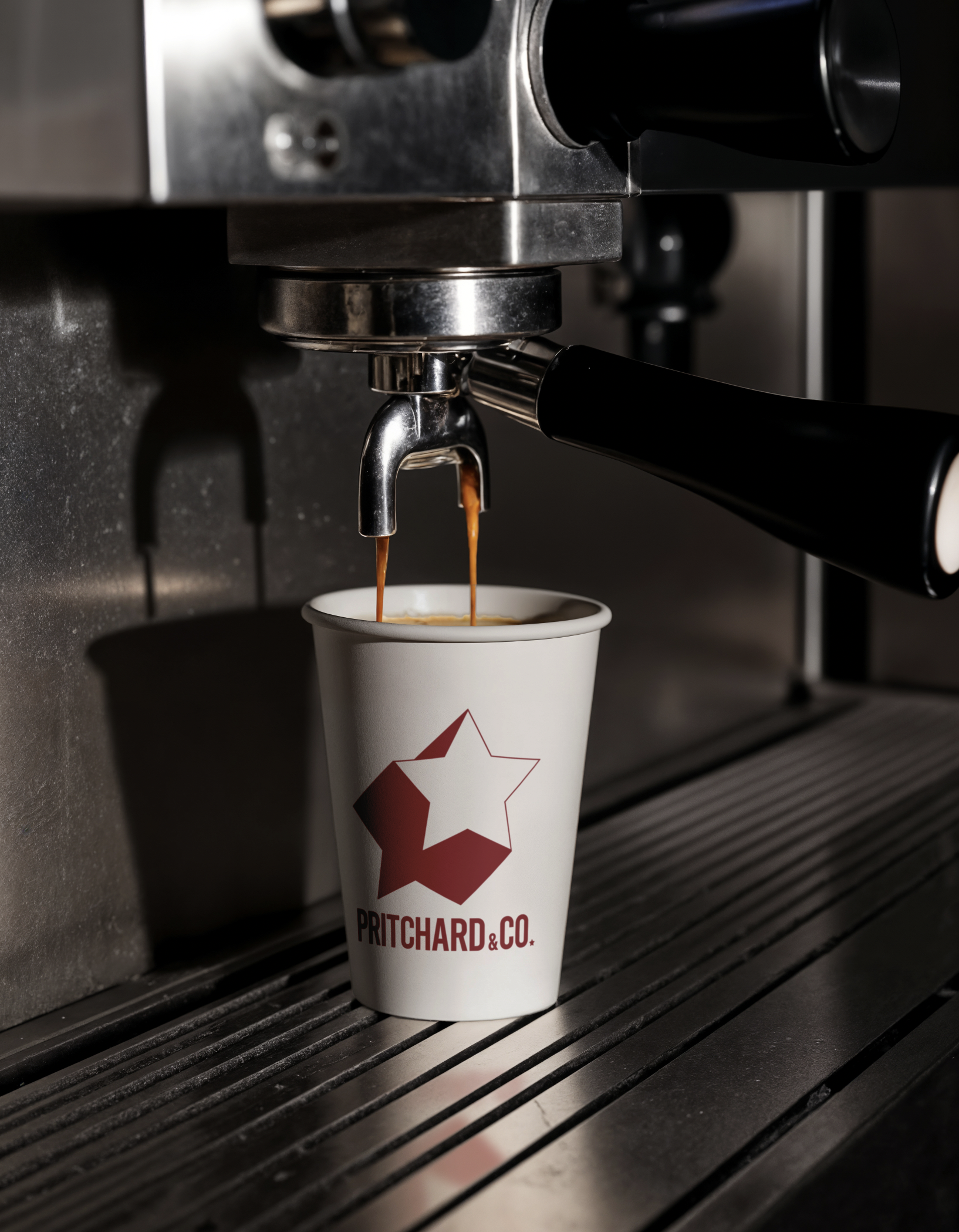 Espresso coffee being brewed into a cup with a logo that says Pritchard & Co.