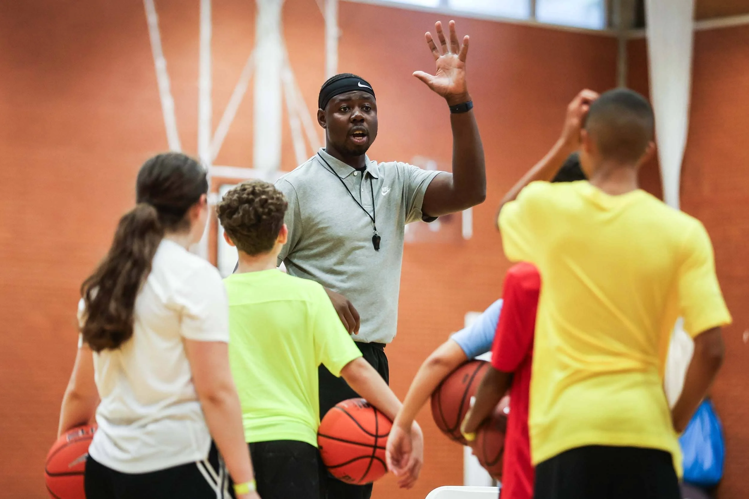 Eric Boateng leads coaching session with basketball players on camp