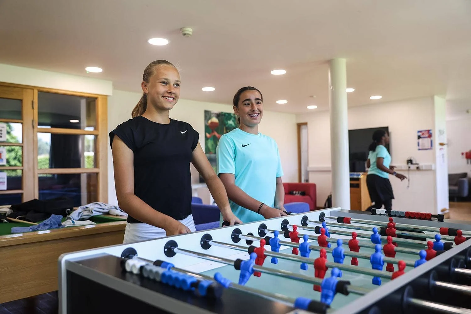 Mädchen spielen Tischfußball und entspannen sich.