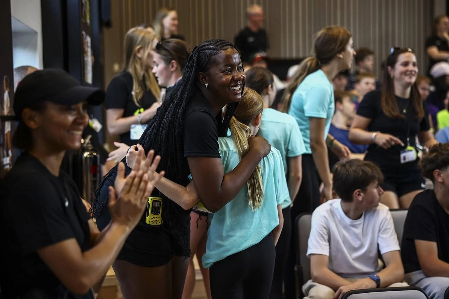 Staff member hugging camper