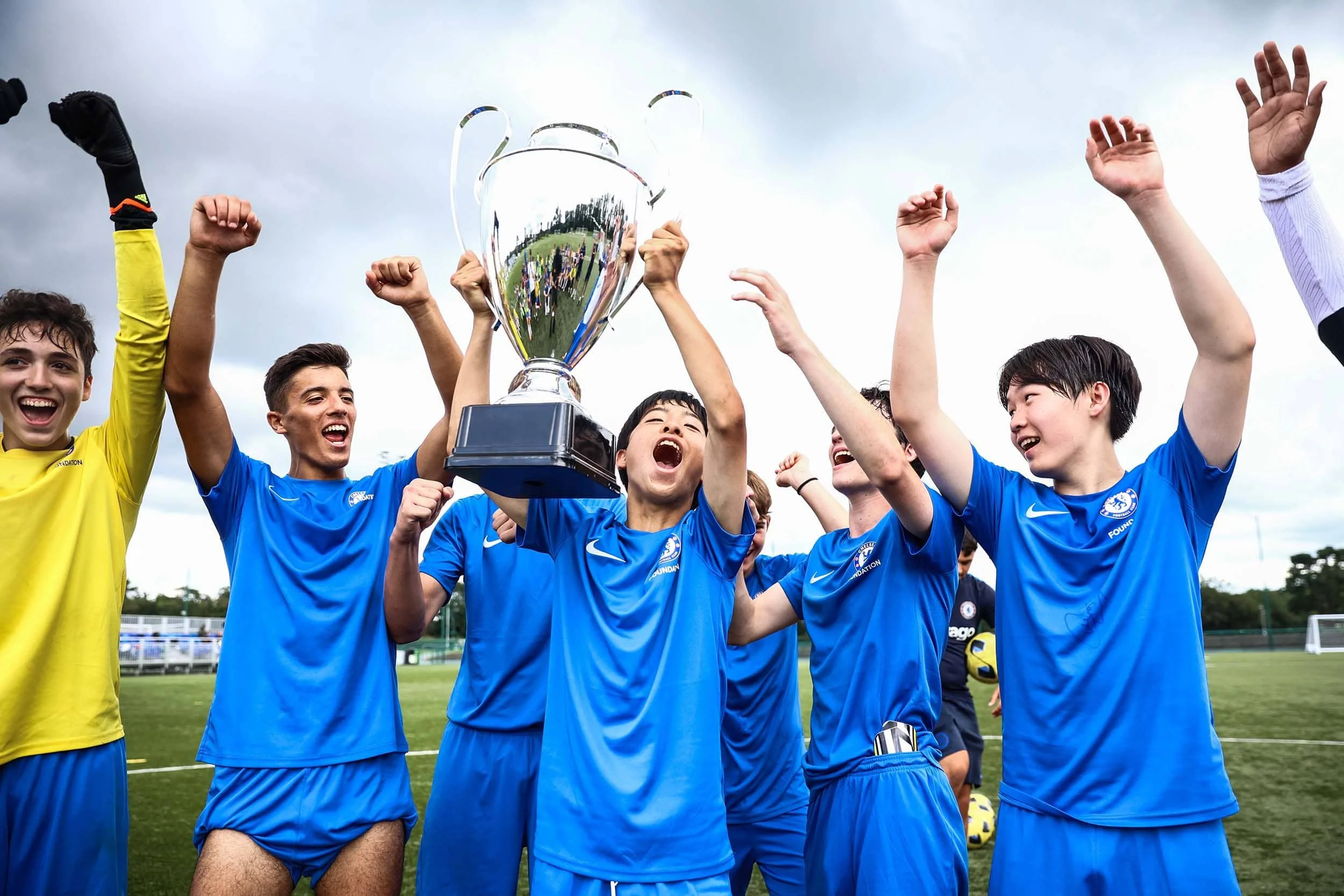 Chelsea FC camp team celebrating with trophy