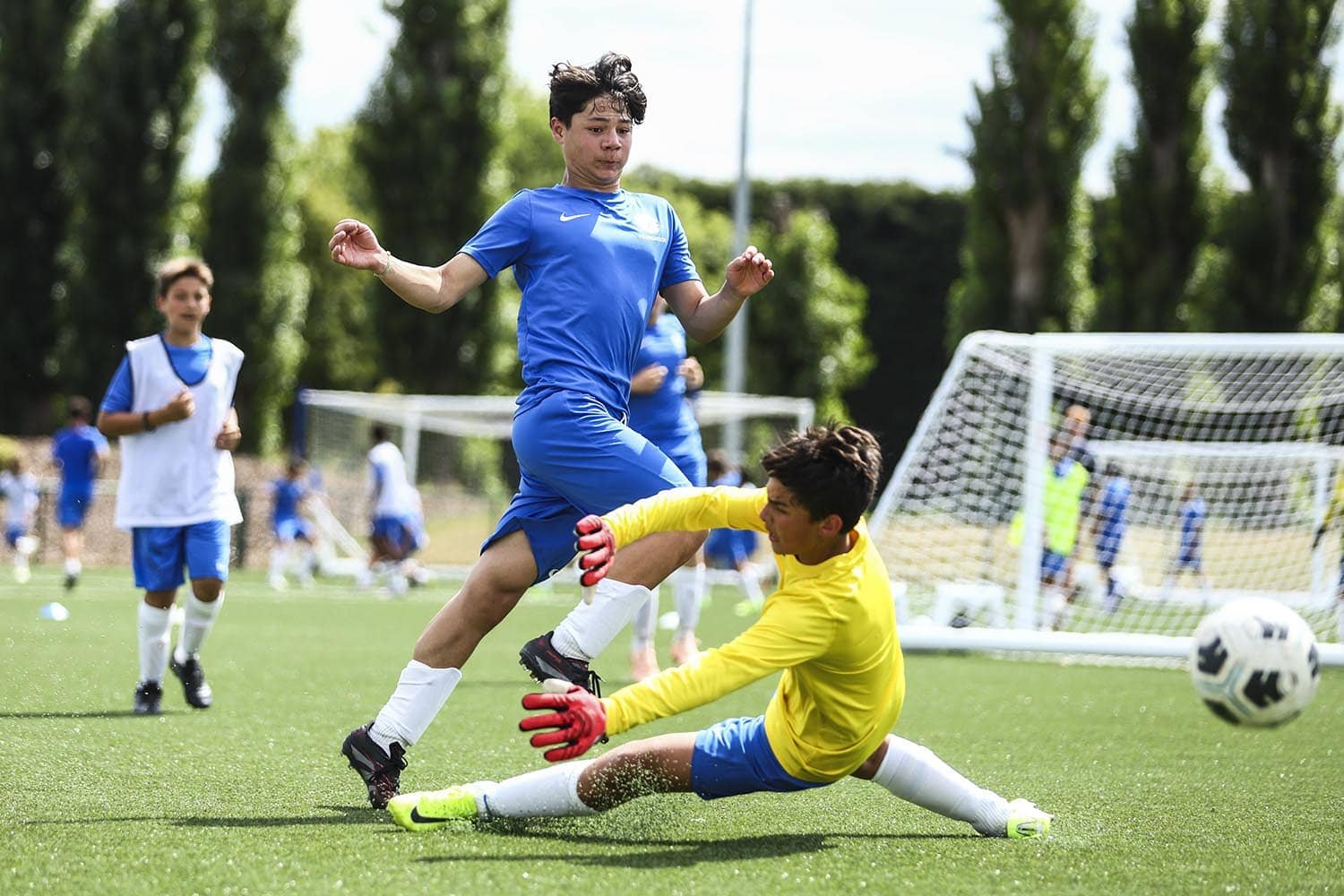 boy scoring goal in competitive match
