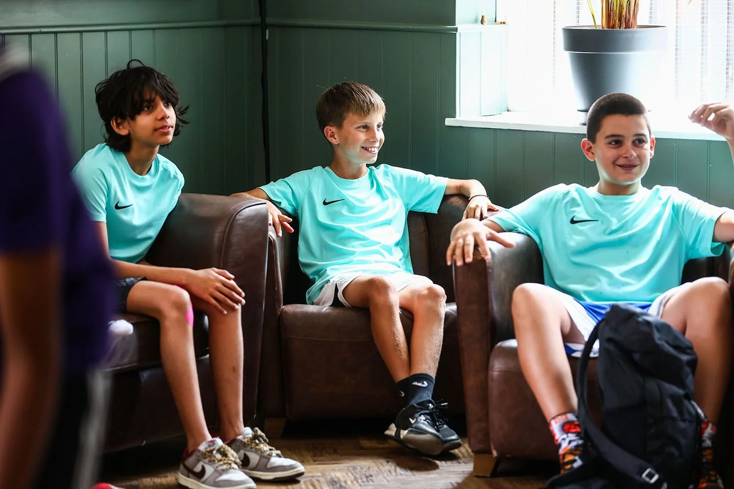 Boys smiling in players lounge