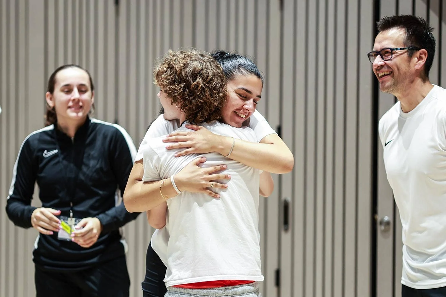 Player and staff member hugging on camp