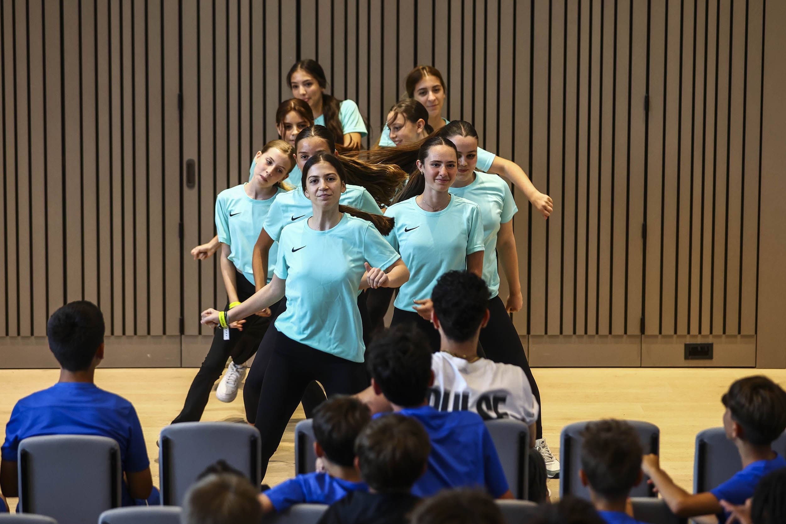 Dance group performing on stage on camp