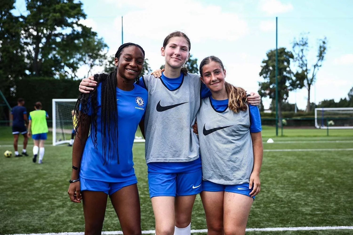 girls from around the world smiling on football camp