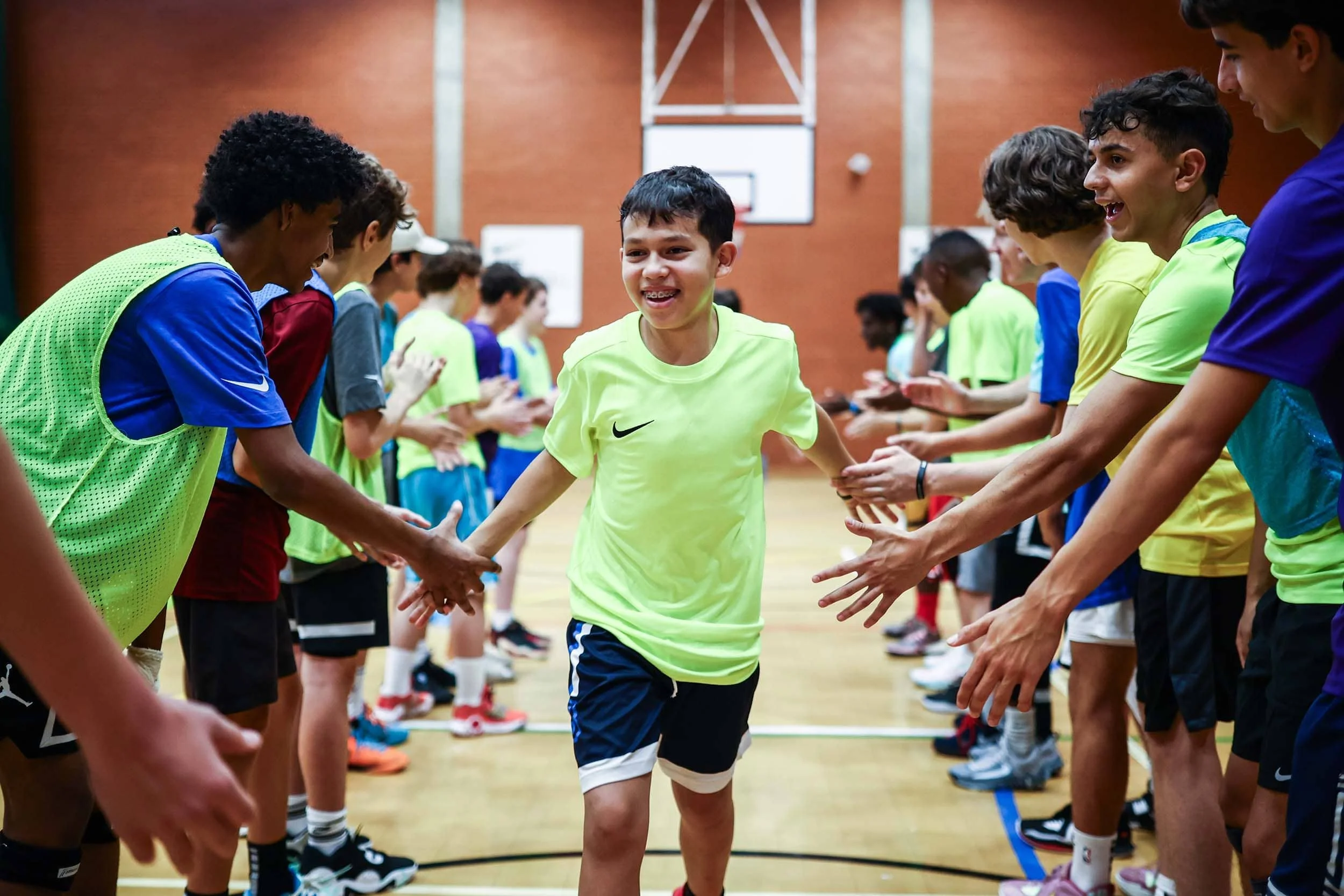 Player on Nike basketball camp high fives teammates