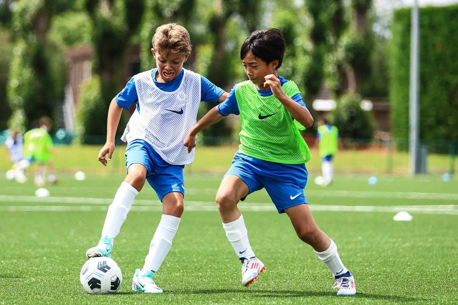 boy dribbling football on chelsea fc camp