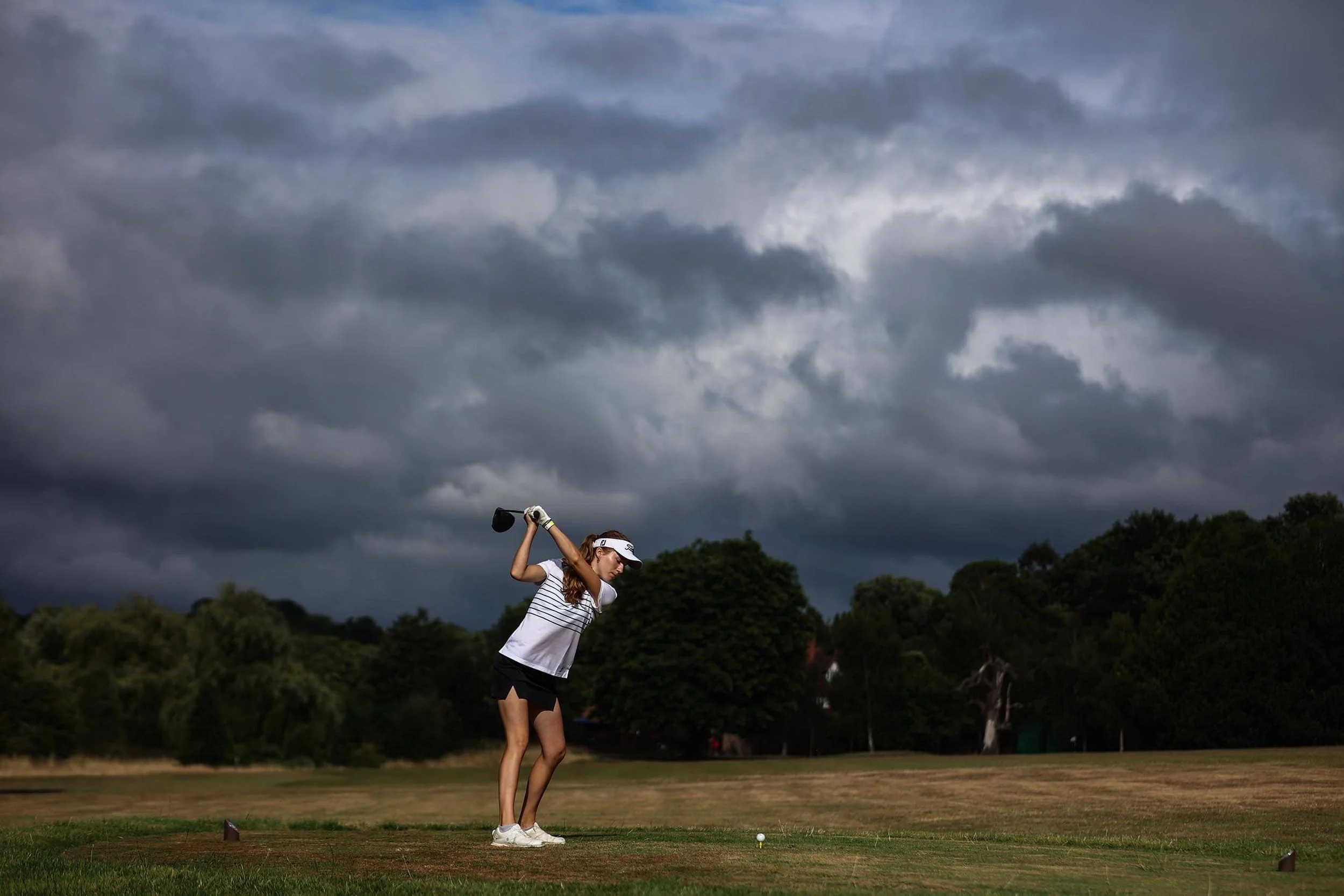Girl practising driving on a stormy day
