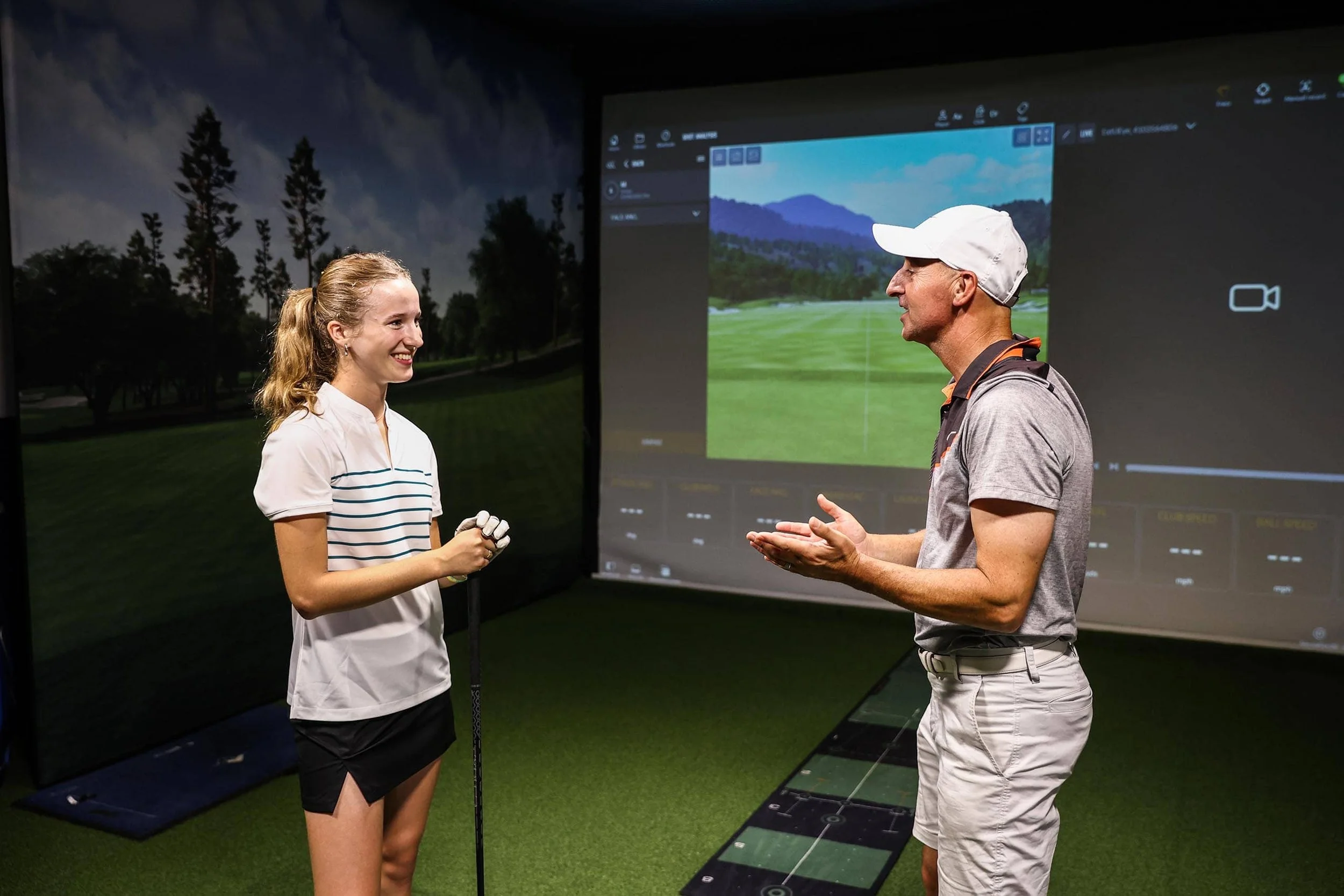 girl with golf instructor learning about golf
