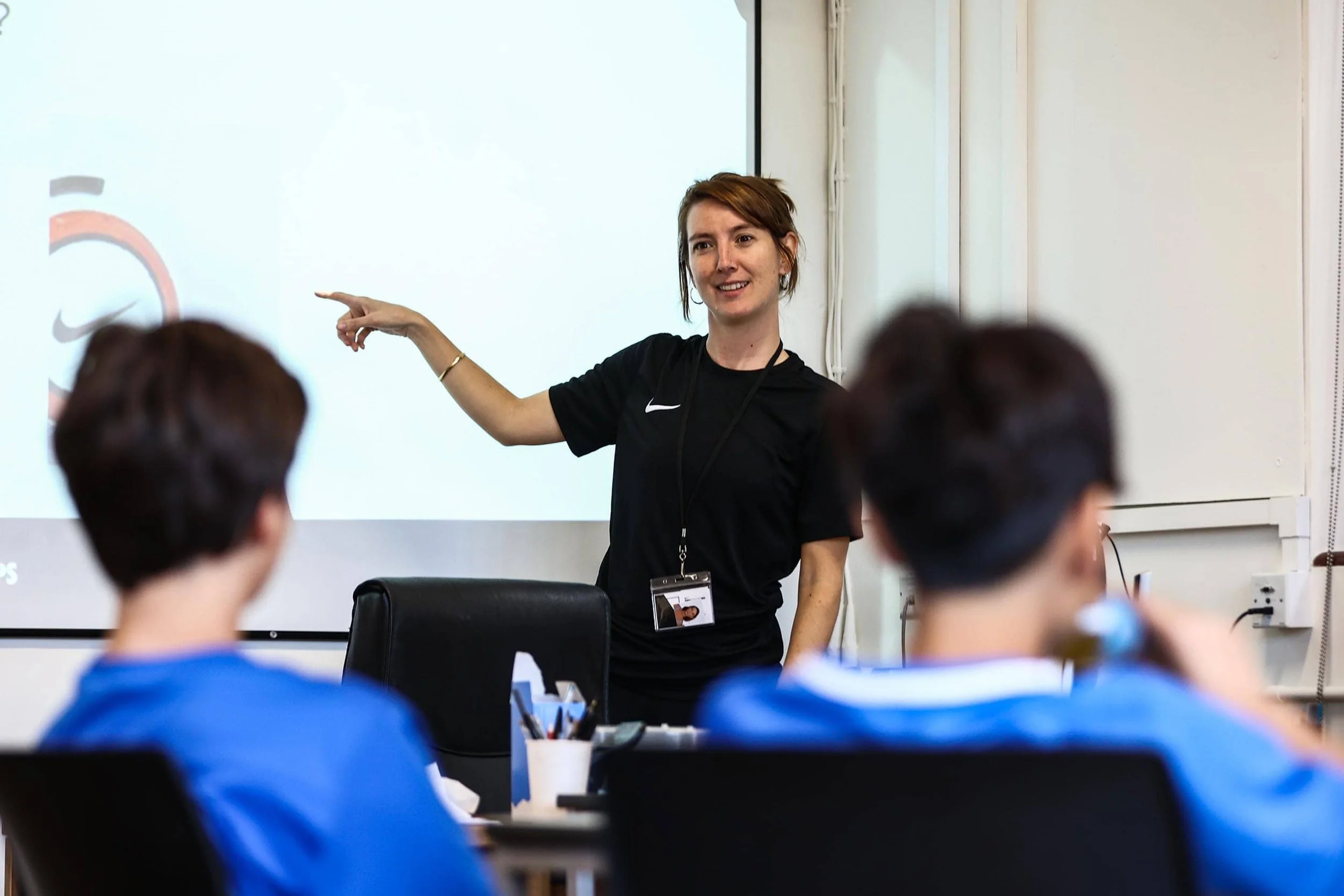 English tutor pointing to classroom board