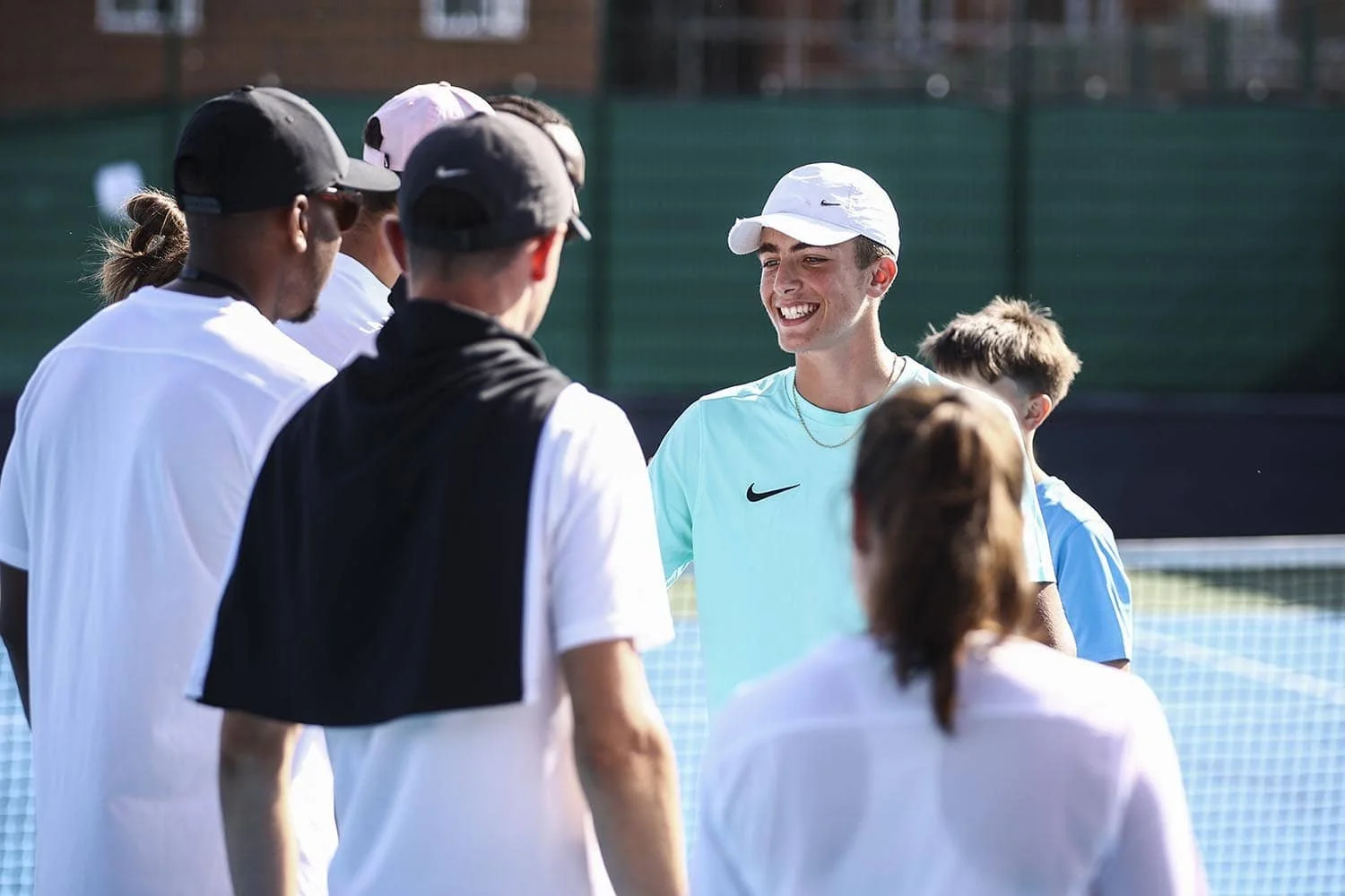 boy smiling shaking hands with coaches