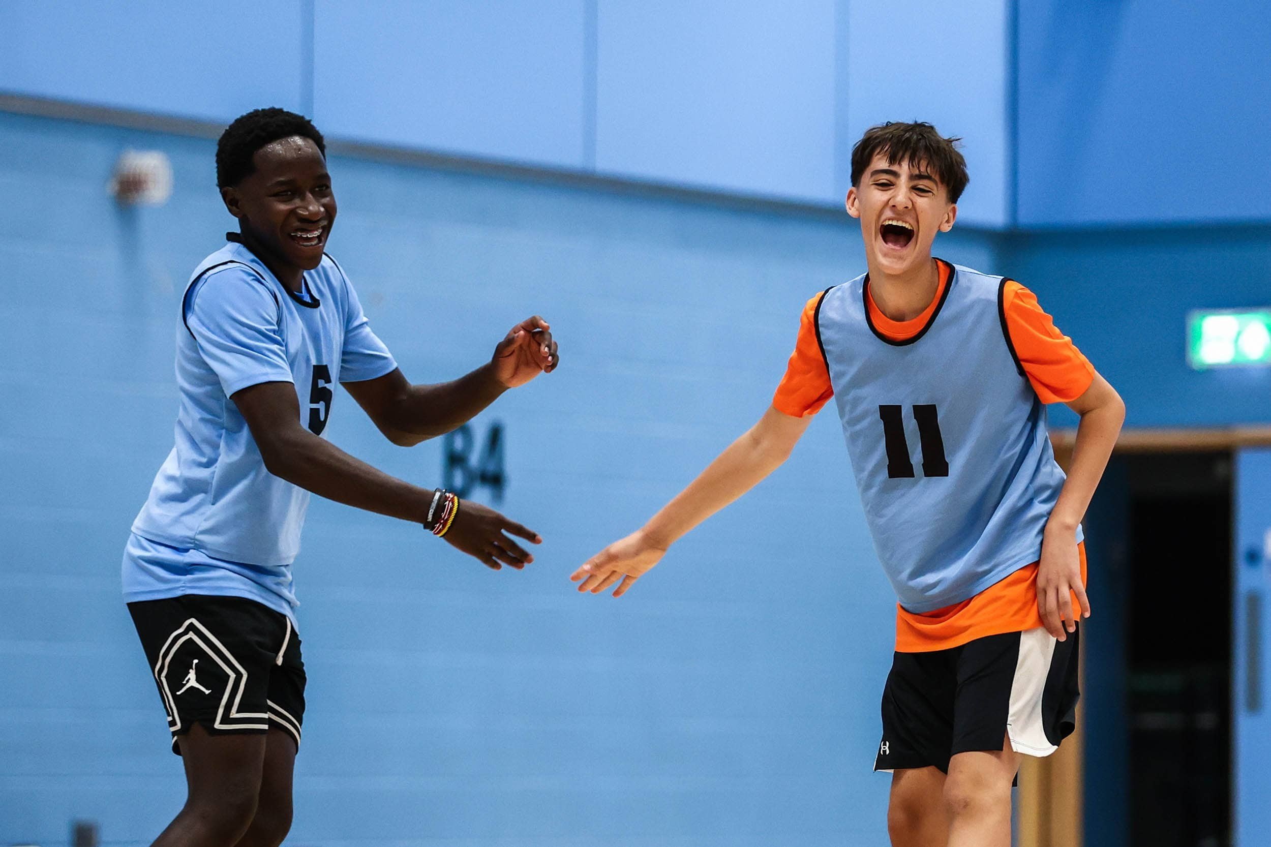 Two basketball players celebrating win